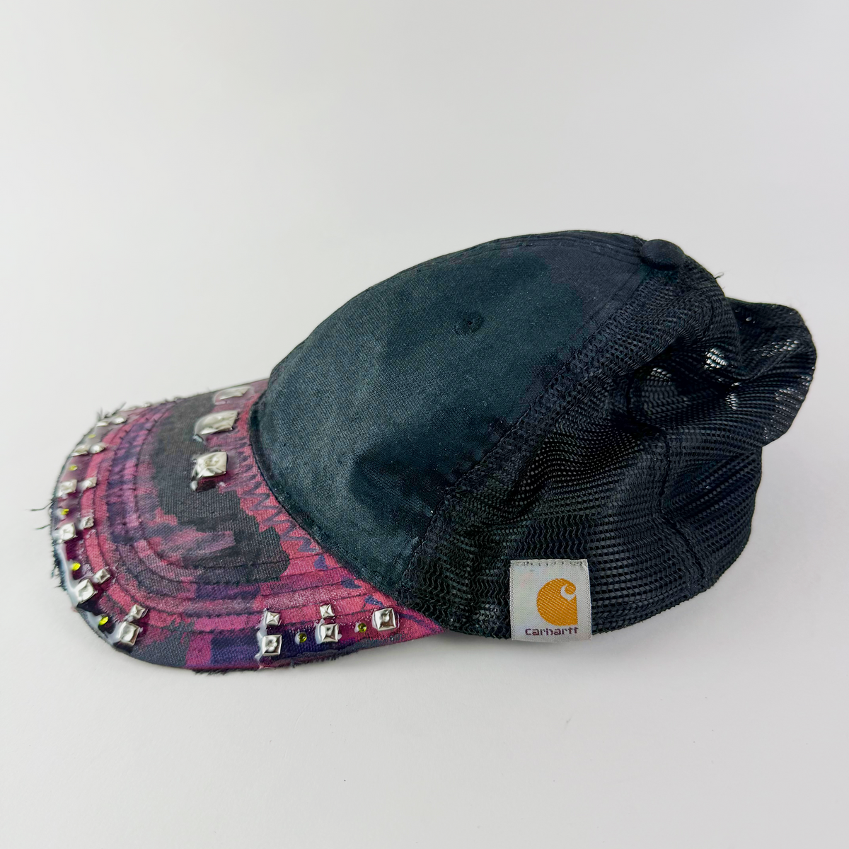 Side view showing black cap, mesh panel, and embellished maroon visor.