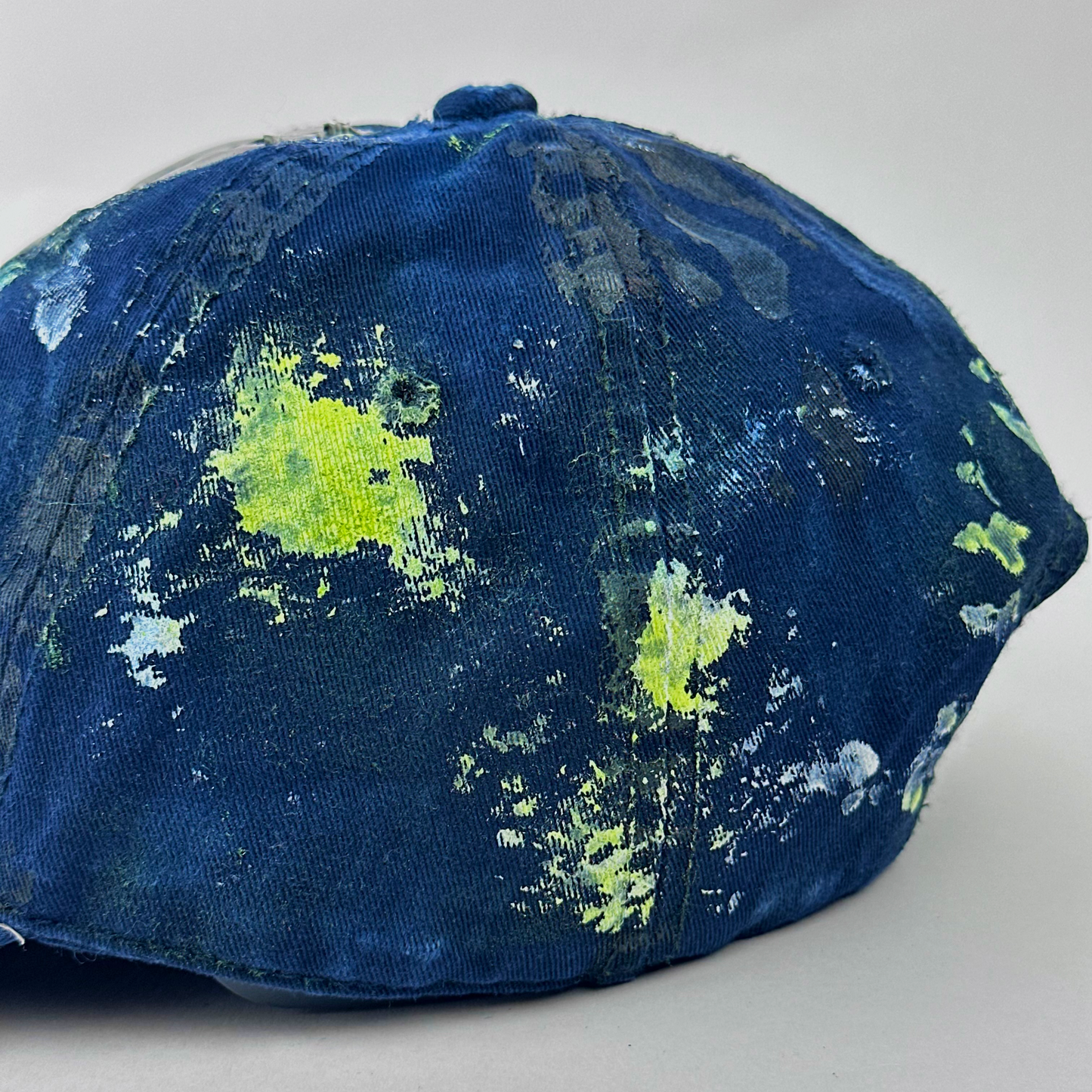 Back side detail of ASTROBOI* 'Coral' showing distressing and speckled paint splatter treatment on blue base.