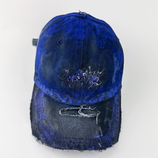 ASTROBOI* 'Damian' gray and black distressed indie hat with indie barbed wire design at front and custom blue haze paint treatment throughout, front view.