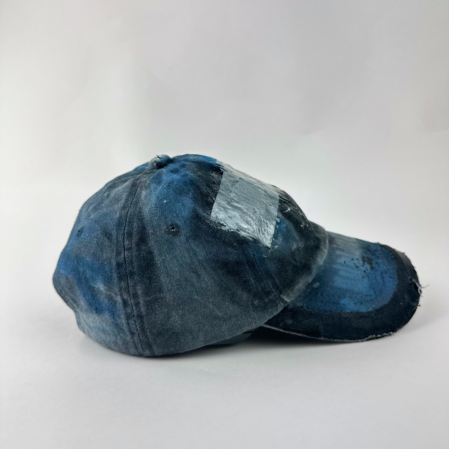 Right side detail of ASTROBOI* 'Duct' showing distressing, fading, and custom paint treatment on blue denim grunge base.