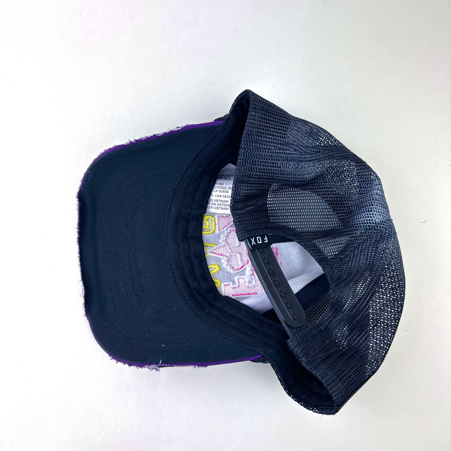 ASTROBOI* x Fox Racing 'Barbed Wire' purple rhinestone hat, rear view showing mesh back panel and adjustable strap.