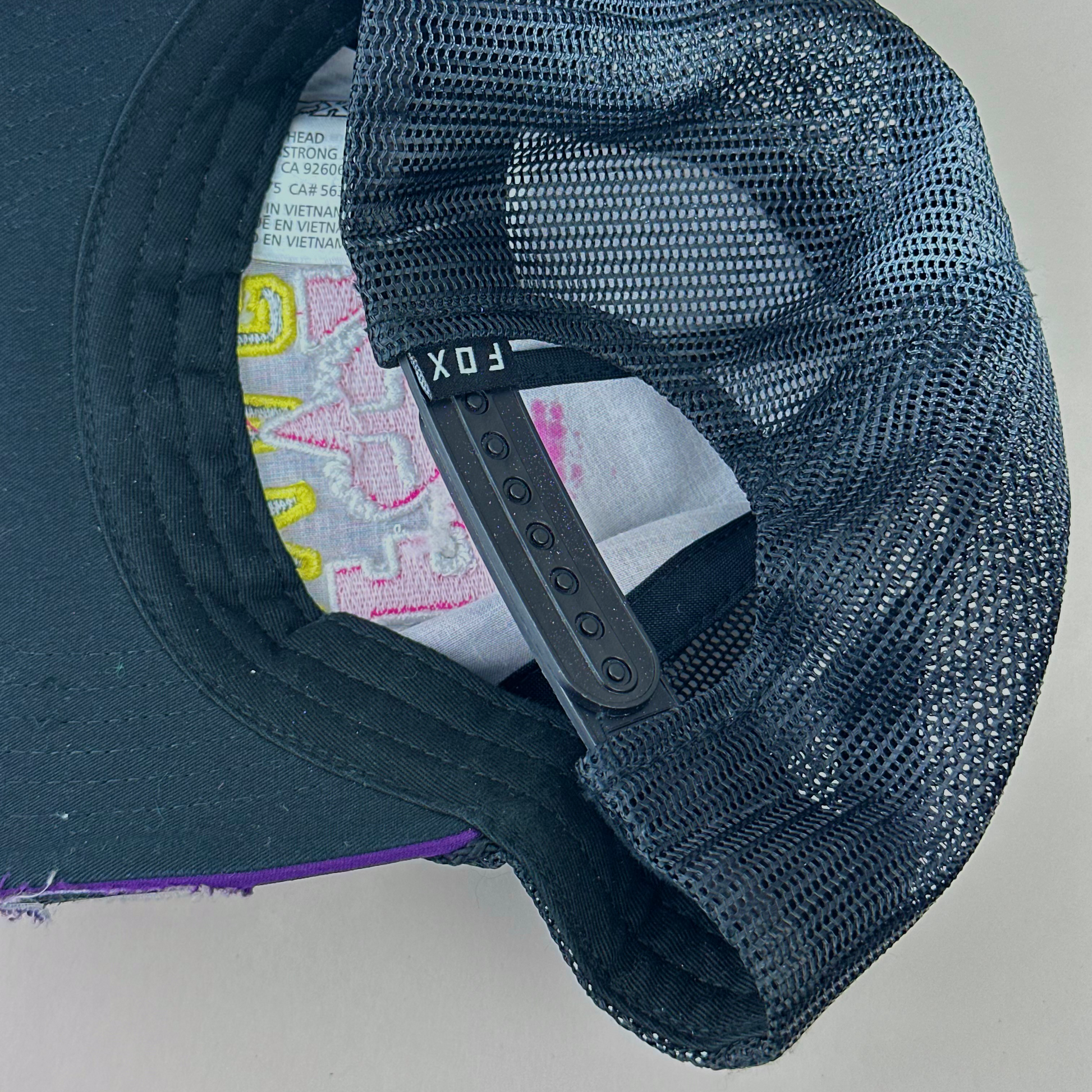 ASTROBOI* x Fox Racing 'Barbed Wire' purple rhinestone hat, rear view showing mesh back panel and adjustable strap.