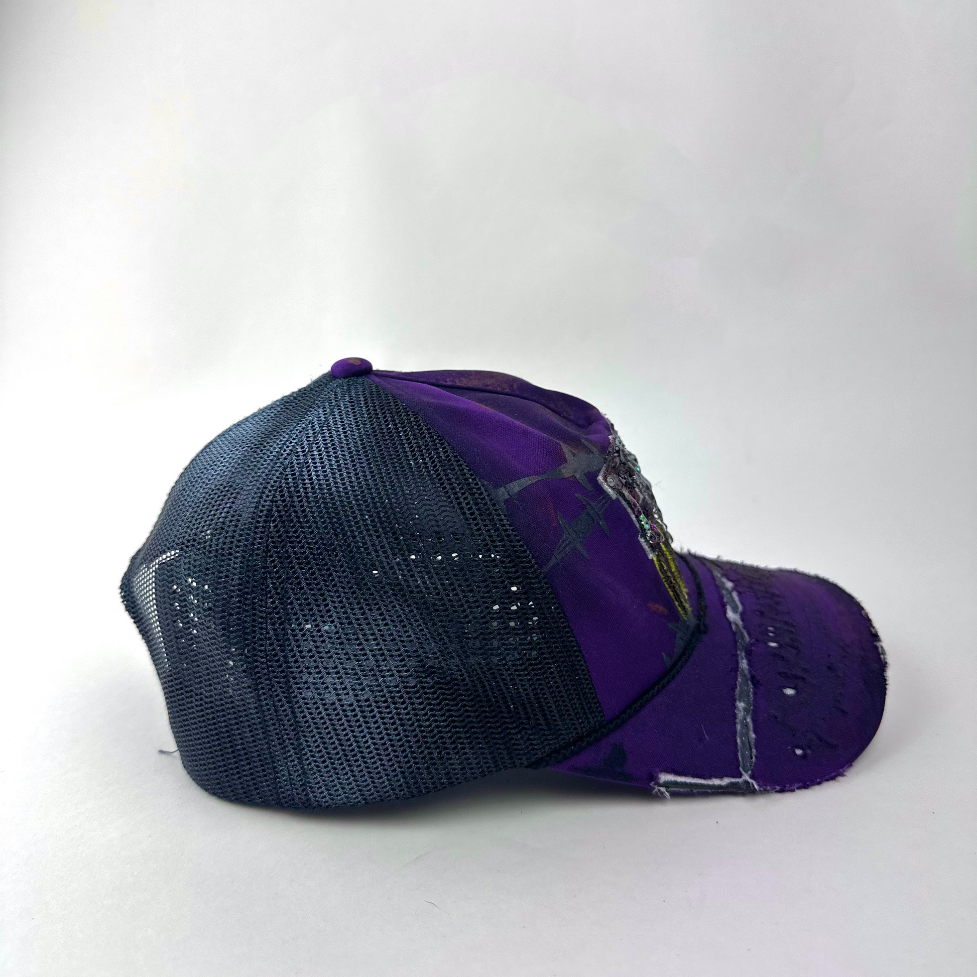 Right side detail of ASTROBOI* x Fox Racing 'Barbed Wire' showing deconstructed visor and custom paint treatment on purple base.