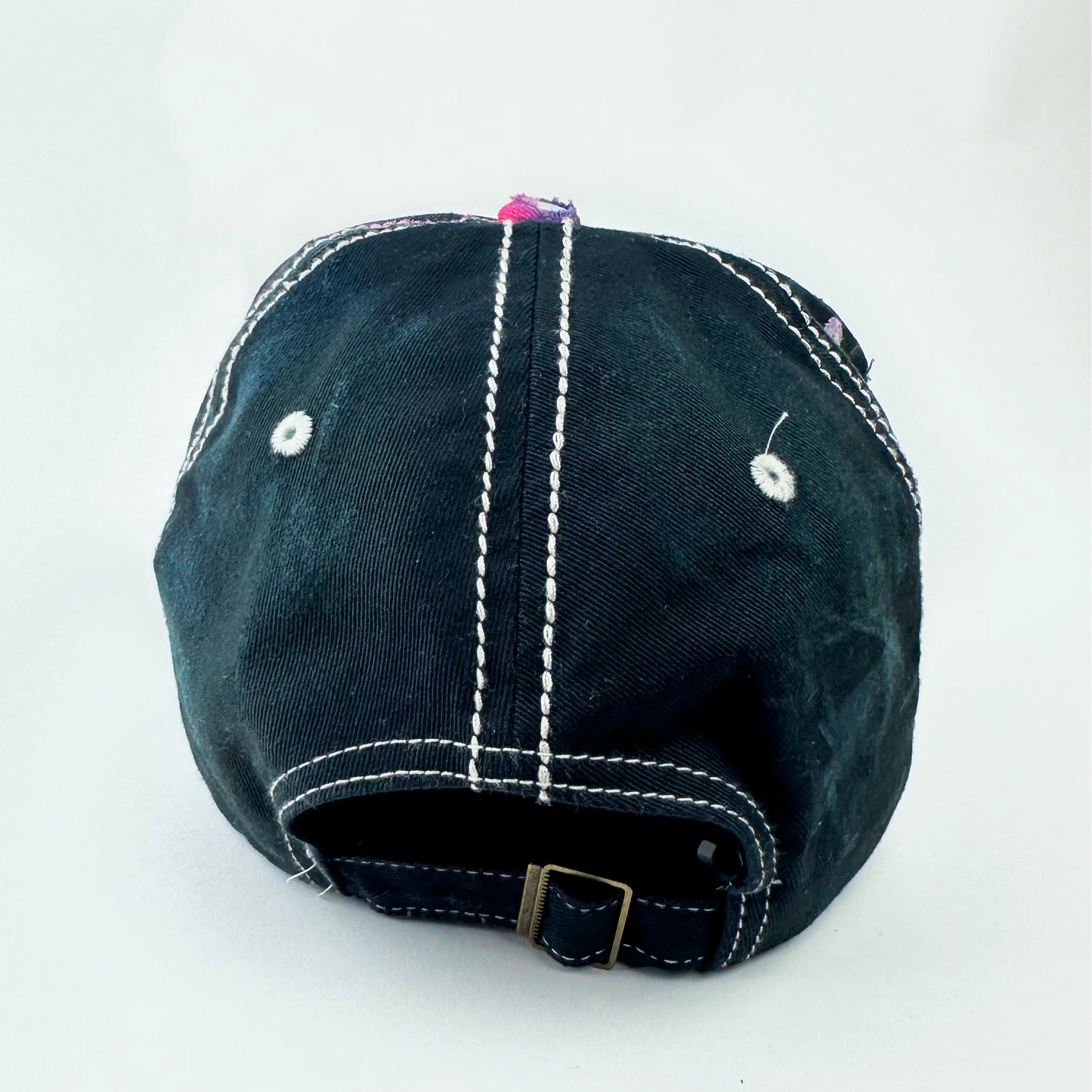 ASTROBOI* 'Hibiscus' red and black Y2K Hawaii rhinestone hat with silver embroidered 'Hawaii ALOHA STATE TRADEMARK' text, purple and pink paint splatter, and metallic rhinestone embellishments, back view.