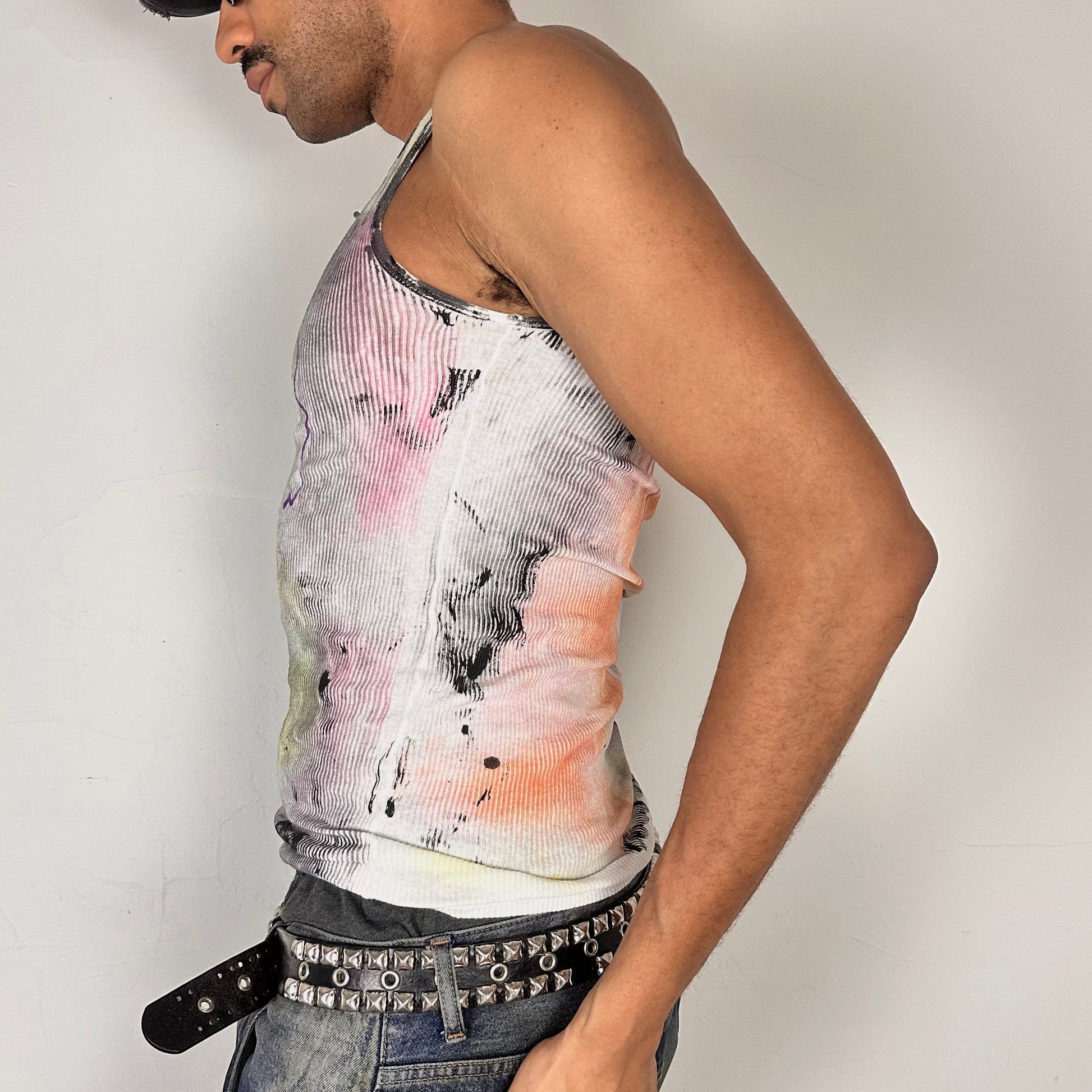 Left side of ASTROBOI* x Hanes 'Plum' white slim-fit tank top with hand-painted multicolor abstract scribble graphic in pink, yellow, blue, and purple, customized at ASTROBOI* STUDIO in NYC.