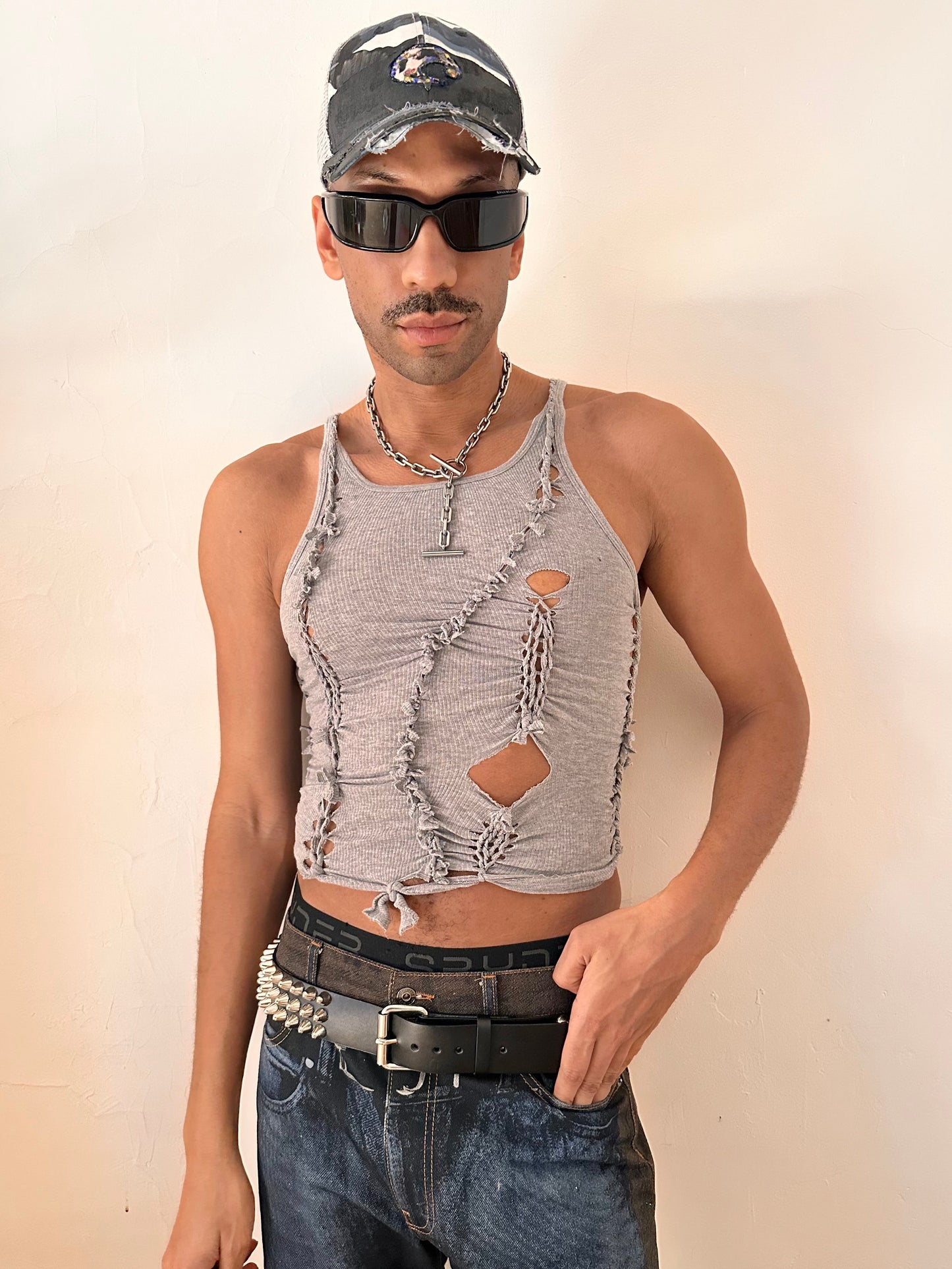 Male model wearing ASTROBOI* 'Ambiguous' gray braided twist tank top, styled full look, ASTROBOI* STUDIO NYC.