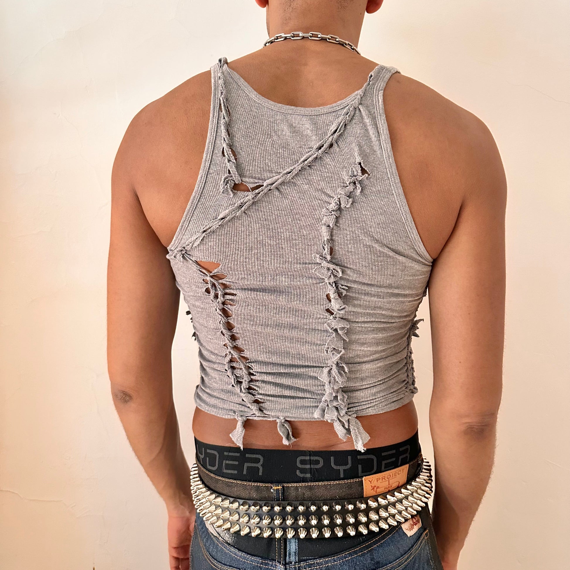 ASTROBOI* 'Ambiguous' gray braided twist tank top, rear view showing braid and slash construction, worn by male model.