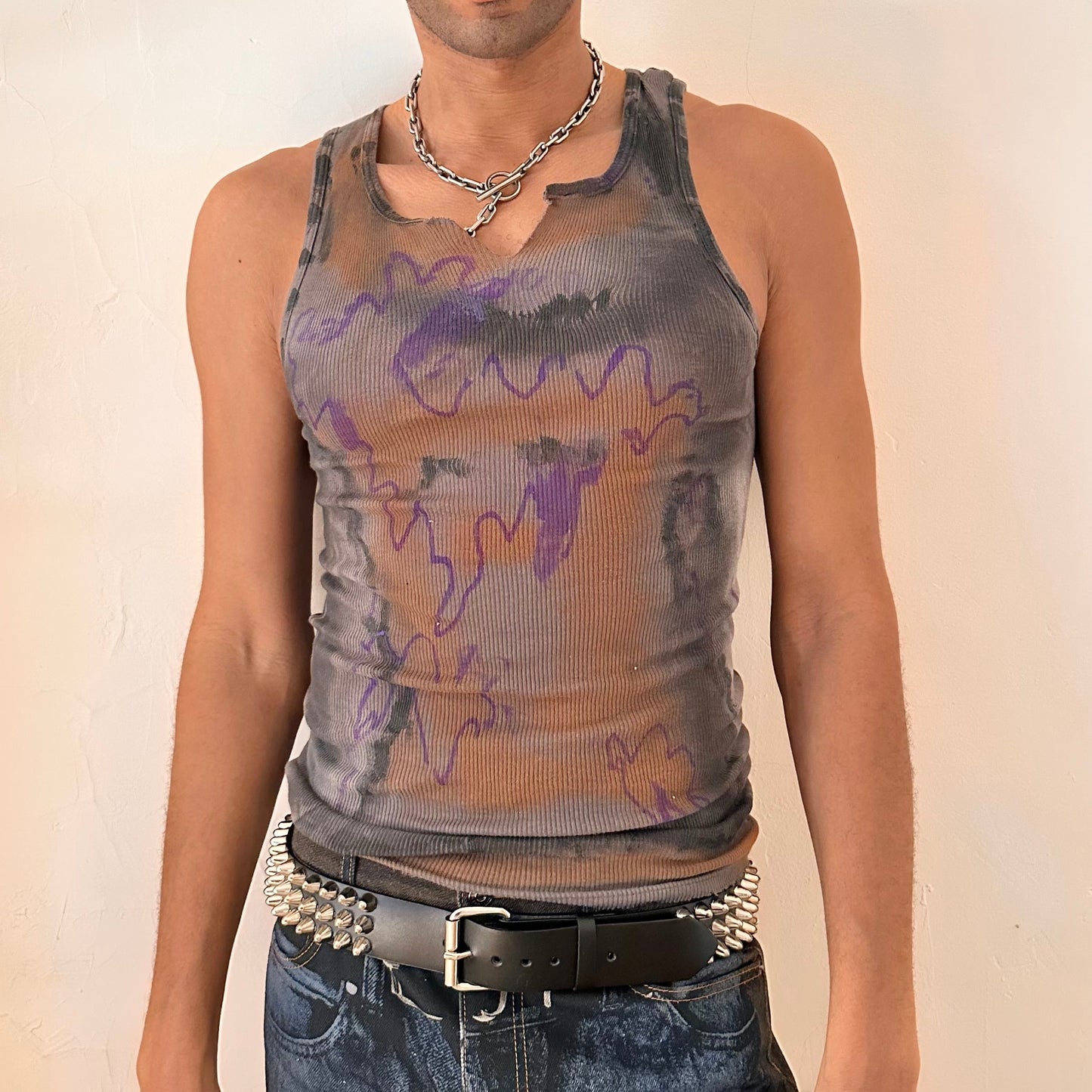 Front of ASTROBOI* x Gildan 'Graffiti' gray ribbed slim-fit tank top with hand-painted purple, white, black, and orange abstract graffiti design and intentional raw rip at the collar, customized at ASTROBOI* STUDIO in NYC.