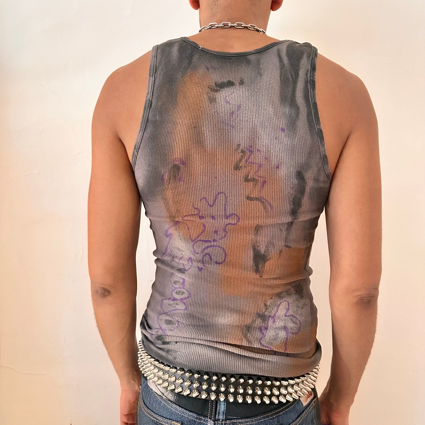 Back of ASTROBOI* x Gildan 'Graffiti' gray ribbed slim-fit tank top with hand-painted purple, white, black, and orange abstract graffiti design and intentional raw rip at the collar, customized at ASTROBOI* STUDIO in NYC.