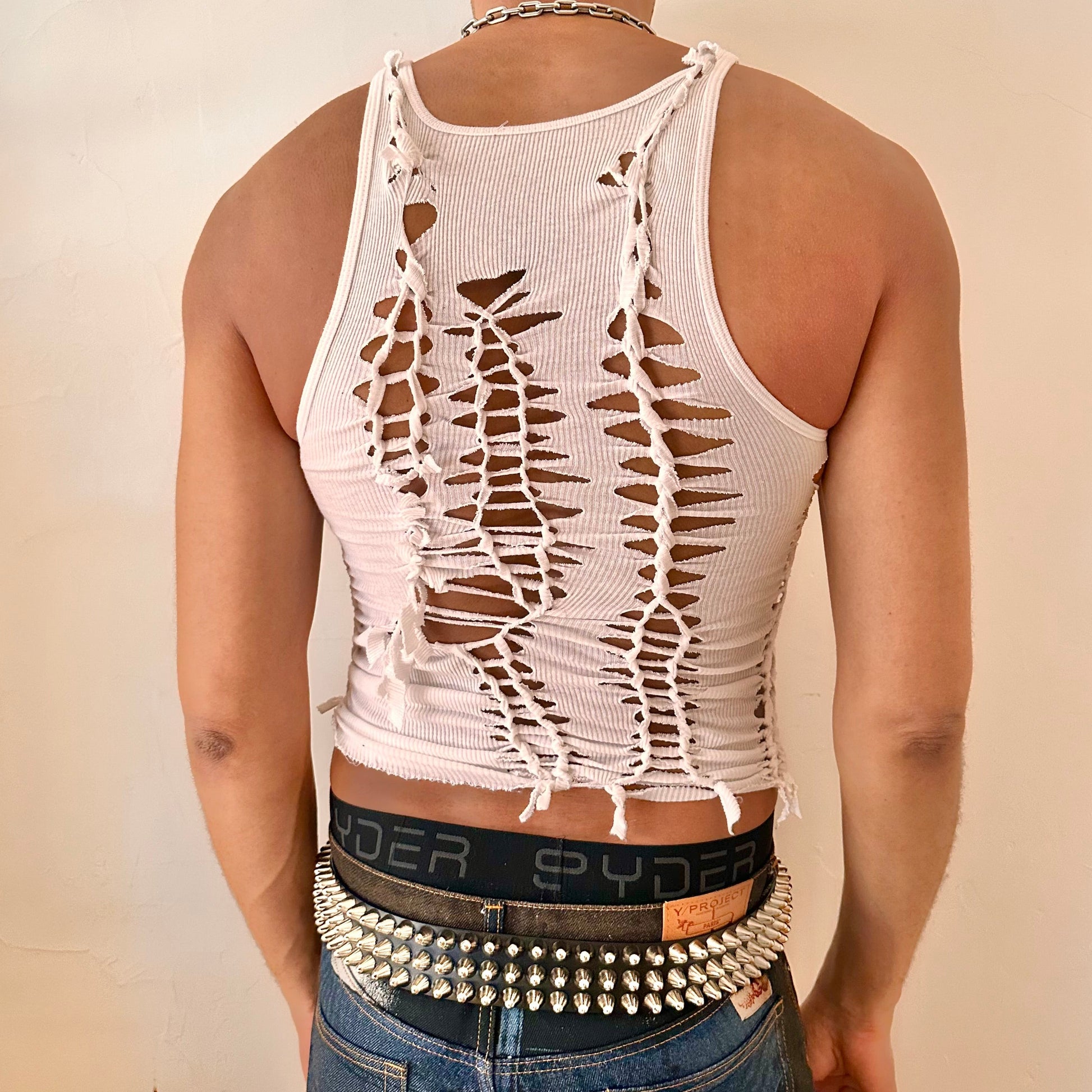 ASTROBOI* 'Trinity' white braided twist tank top, rear view showing braid and cut-out construction, worn by male model.