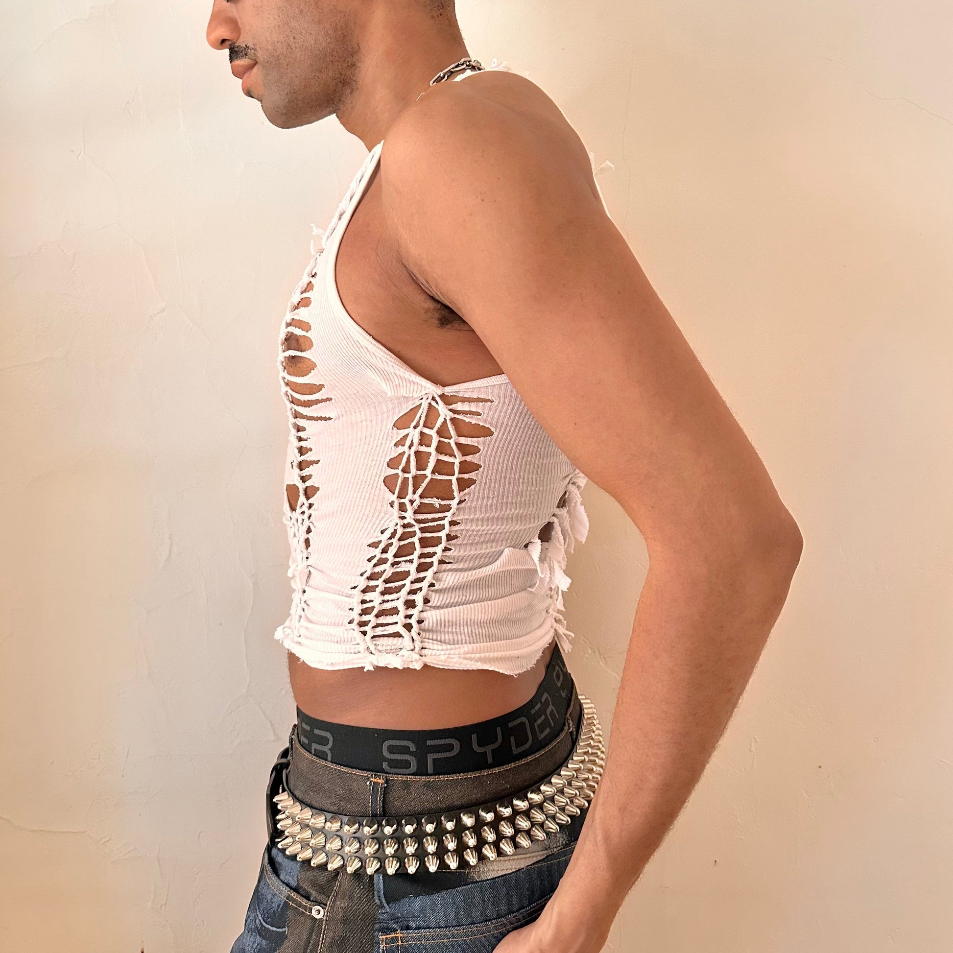 Left side detail of ASTROBOI* 'Trinity' showing hand-braided arrangement and cut-out detailing on cropped white cotton tank.