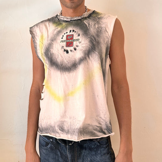 ASTROBOI* x Fox Racing white boxy-fit motocross tank top with black and acid yellow airbrush streaks, punched holes throughout front, and raw hem, front view.