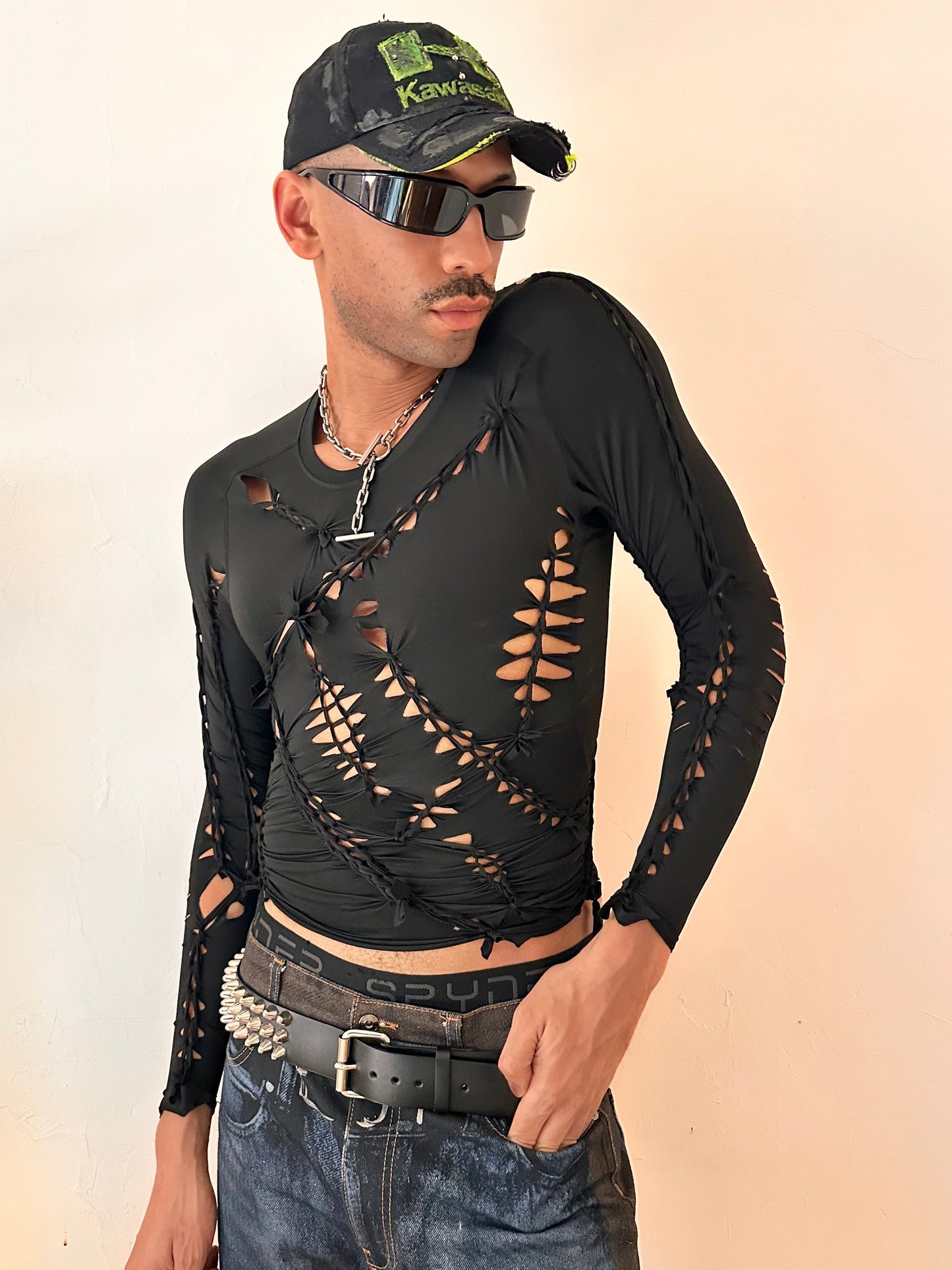 Male model wearing ASTROBOI* 'LEO' black braided spandex compression top, styled full look, ASTROBOI* STUDIO NYC.