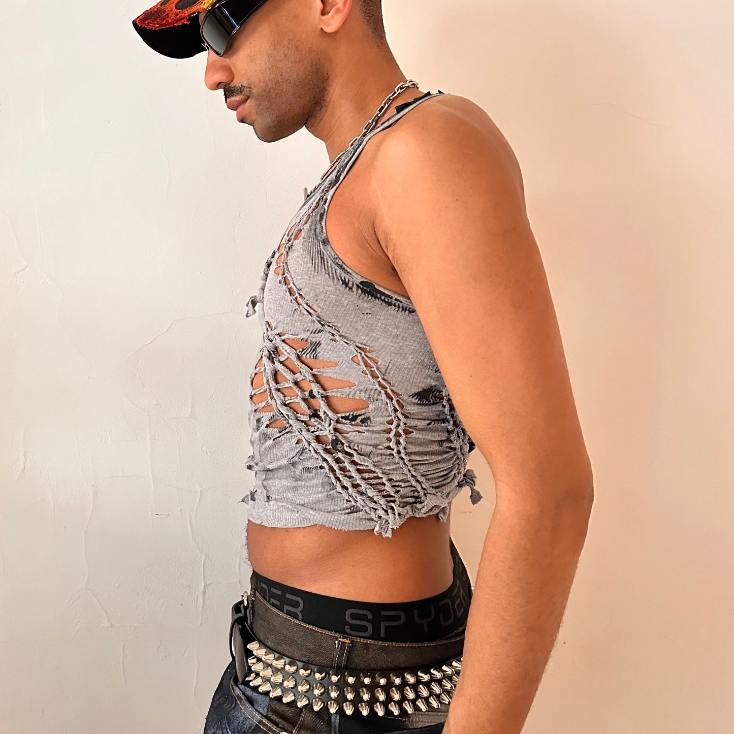  Left side detail of ASTROBOI* 'Hybrid' showing hand-braided arrangement, cut-outs, and black paint detailing along shoulder and body on gray tank.