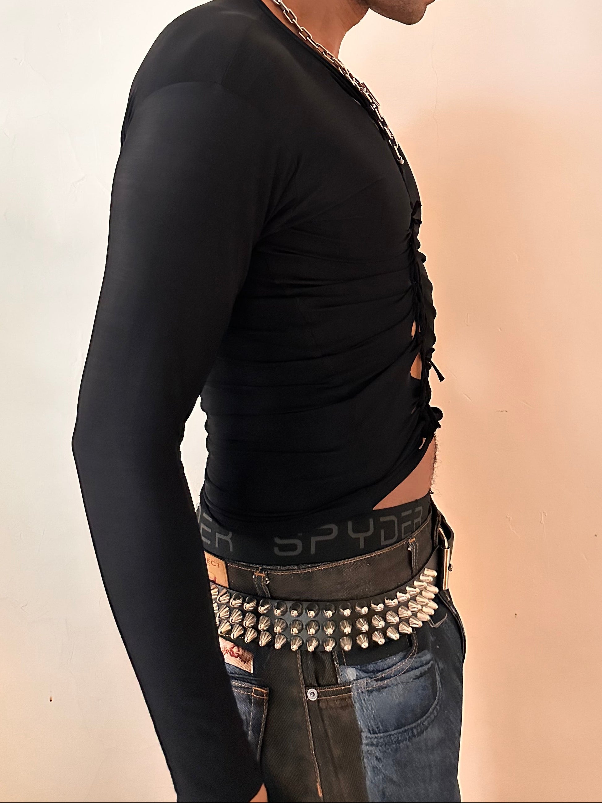 Right side of ASTROBOI* x Under Armour black braided compression top in large with slim stretch fit, twist detailing, and UA logos at chest and back.