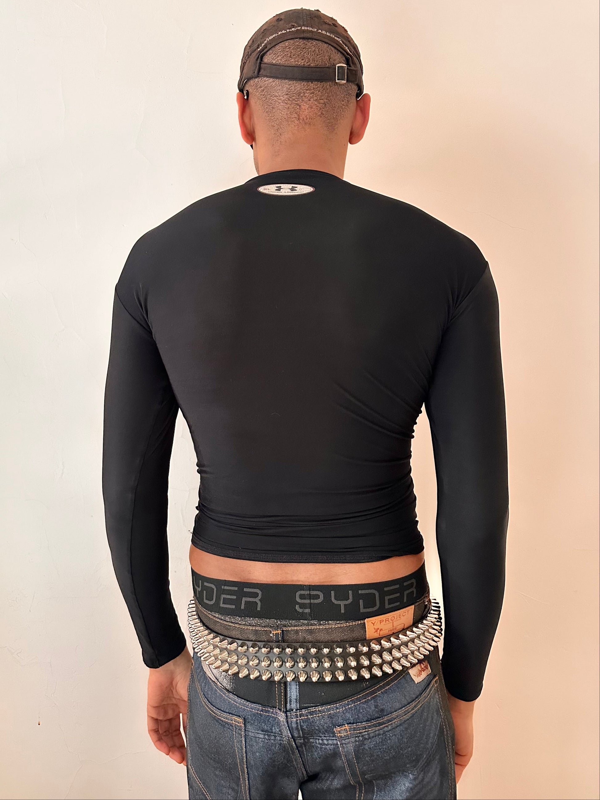 Back of ASTROBOI* x Under Armour black braided compression top in large with slim stretch fit, twist detailing, and UA logos at chest and back.