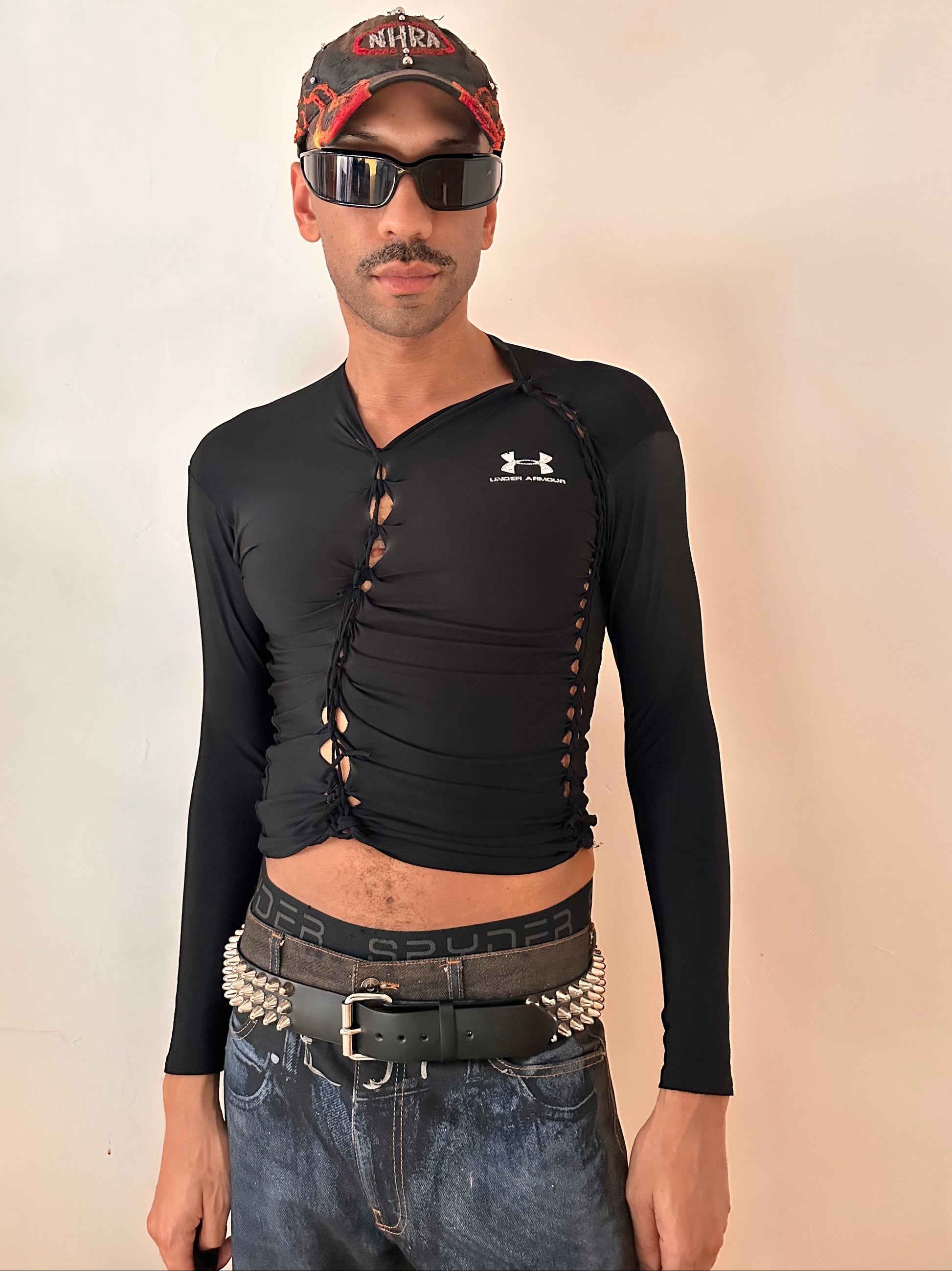 Front overview of ASTROBOI* x Under Armour black braided compression top in large with slim stretch fit, twist detailing, and UA logos at chest and back.