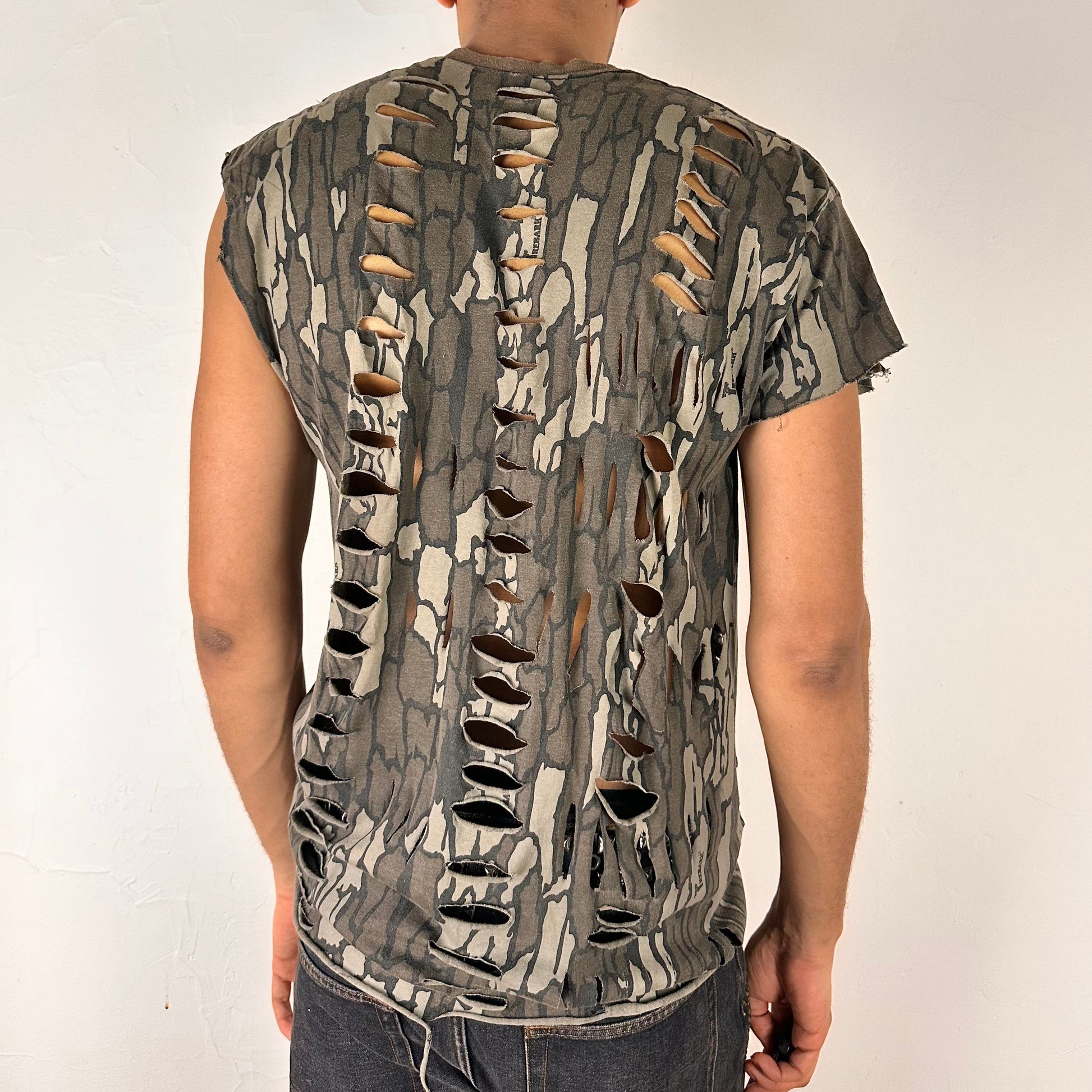 ASTROBOI* 'Maelstrom' Real Tree camo rhinestone tank top, rear view showing loose-fit construction and rhinestone detail, worn by male model.