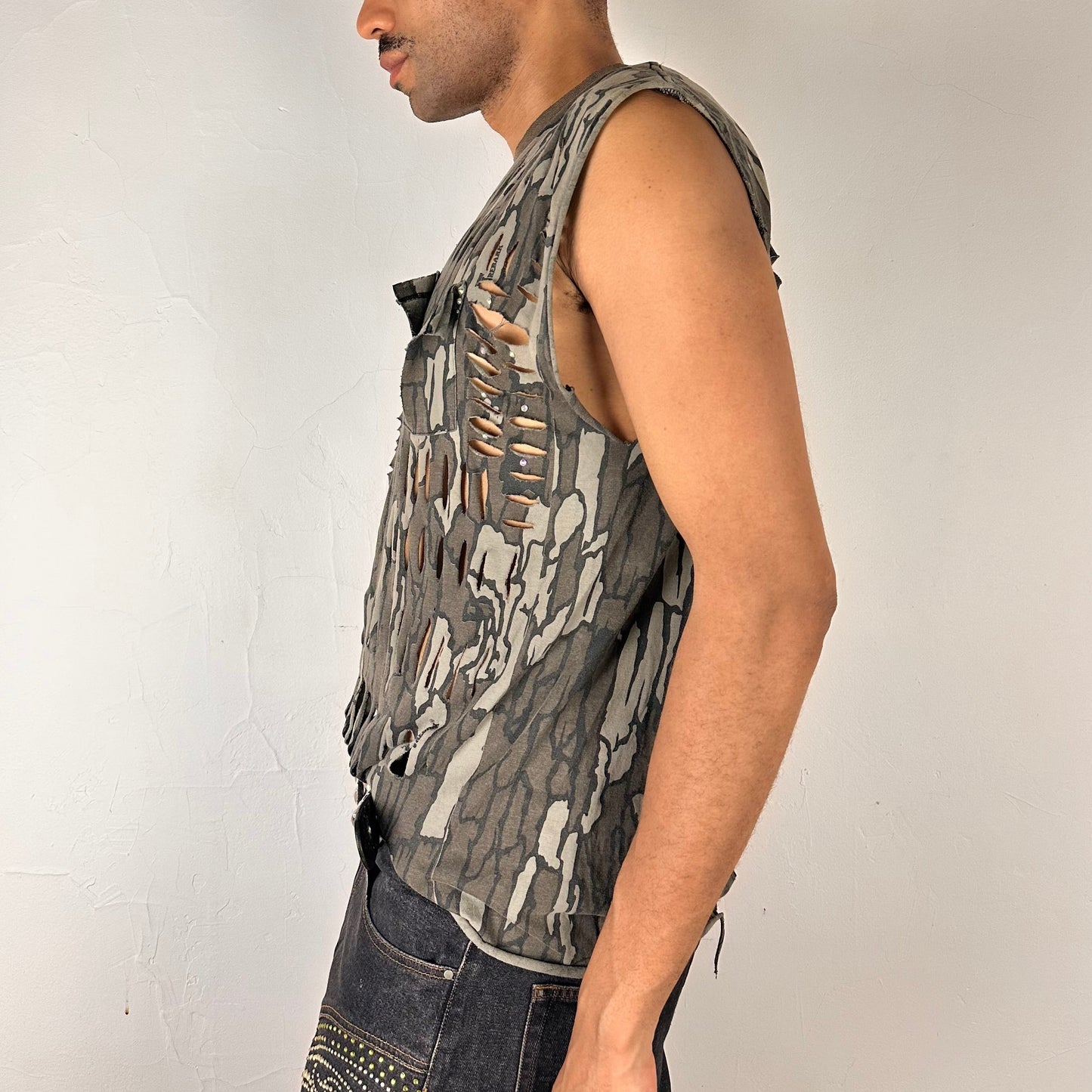 Left side detail of ASTROBOI* 'Maelstrom' showing rainbow rhinestone detailing and deconstructed pocket construction on camo tank.