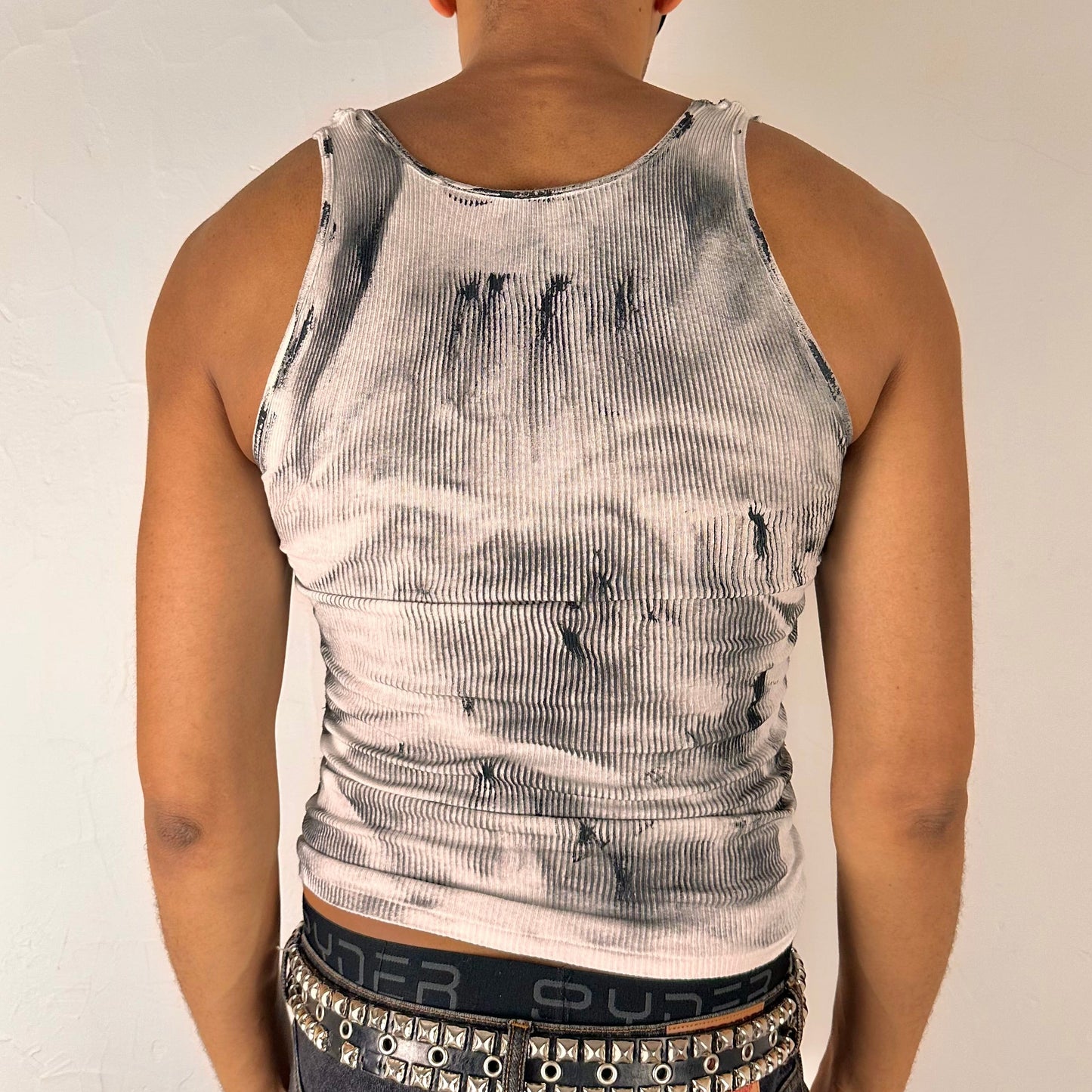 ASTROBOI* 'Theia' white and black braided twist top, rear view showing braid, slash, and two-toned paint construction, worn by male model.