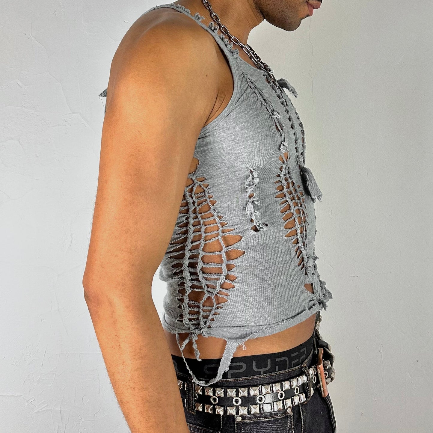 Right side detail of ASTROBOI* 'Smoke' showing braided twist, knot, and cut-out construction on close-fitting gray stretch base.