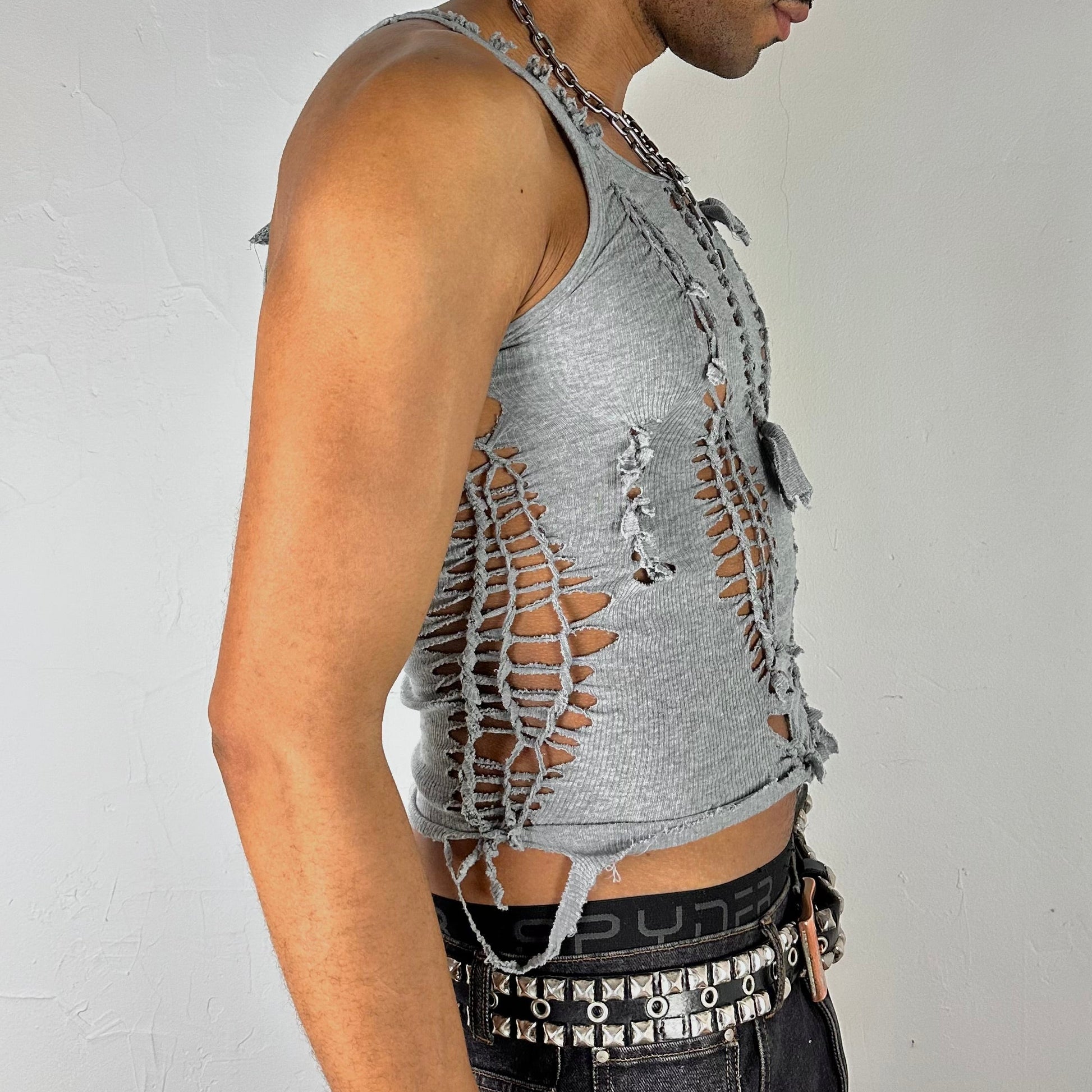Right side detail of ASTROBOI* 'Smoke' showing braided twist, knot, and cut-out construction on close-fitting gray stretch base.