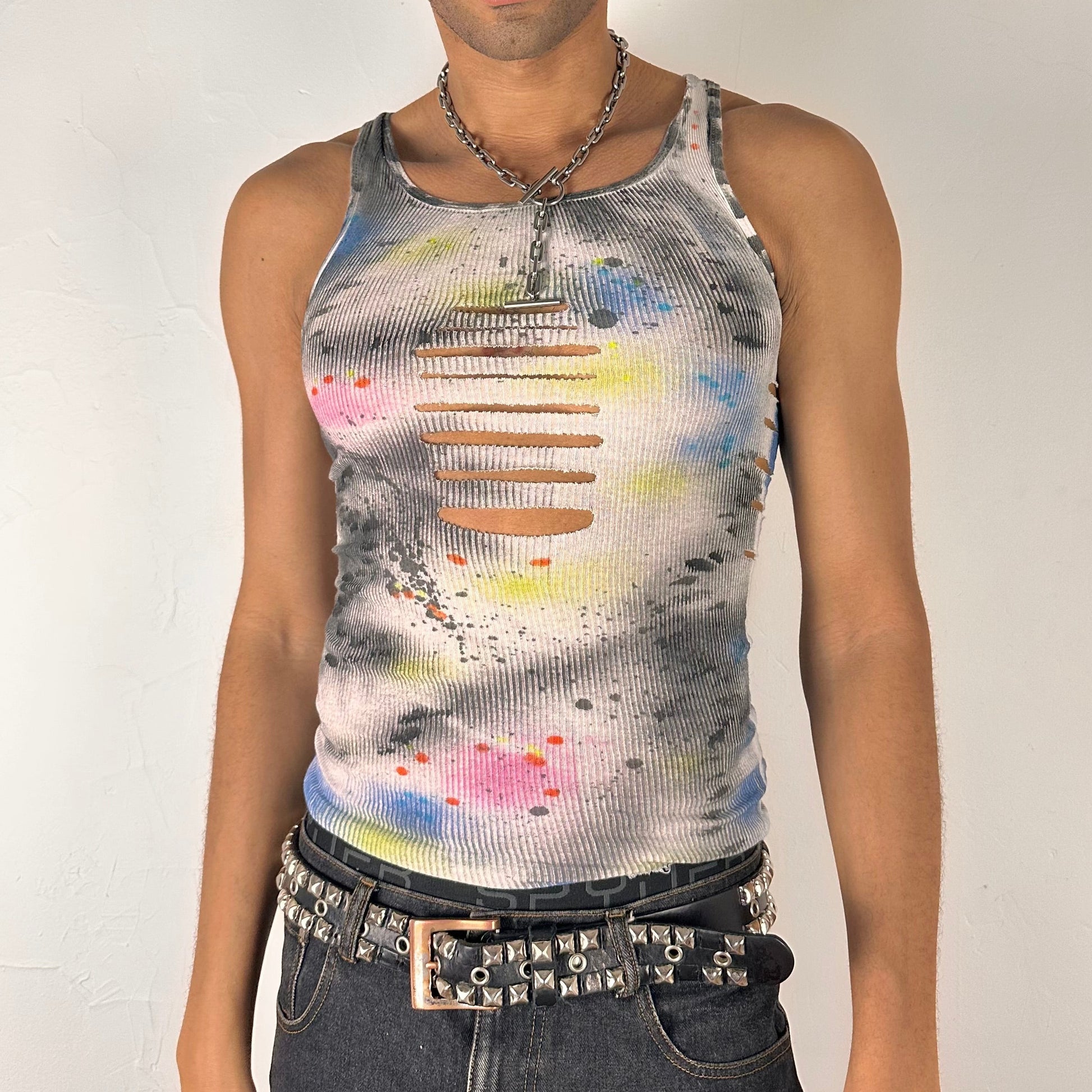 Front of ASTROBOI* x Hanes 'HEAVEN' white ribbed cotton tank top with hand-painted pink, yellow, black, and blue abstract graphic, deconstructed cut-outs along chest and sides, customized at ASTROBOI* STUDIO in NYC.
