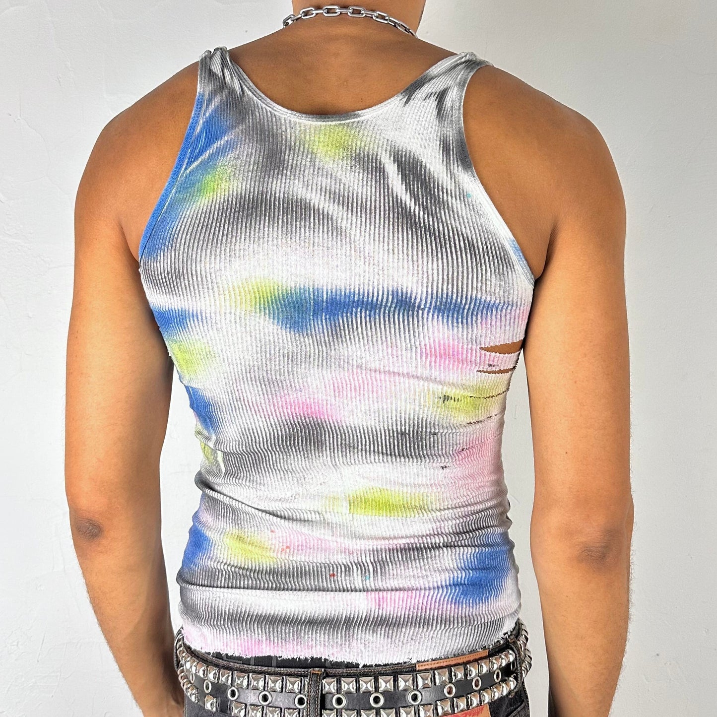 Back of ASTROBOI* x Hanes 'HEAVEN' white ribbed cotton tank top with hand-painted pink, yellow, black, and blue abstract graphic, deconstructed cut-outs along chest and sides, customized at ASTROBOI* STUDIO in NYC.