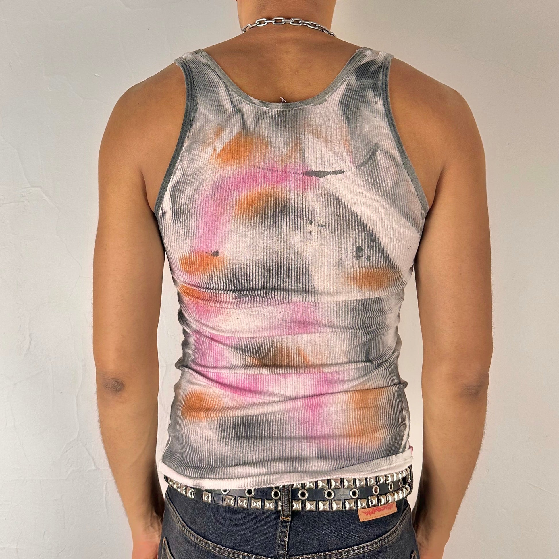 Back of ASTROBOI* x Hanes 'Mars' white ribbed cotton tank top with hand-painted pink, orange, and black abstract graphic, deconstructed cut-outs along chest and sides, customized at ASTROBOI* STUDIO in NYC.