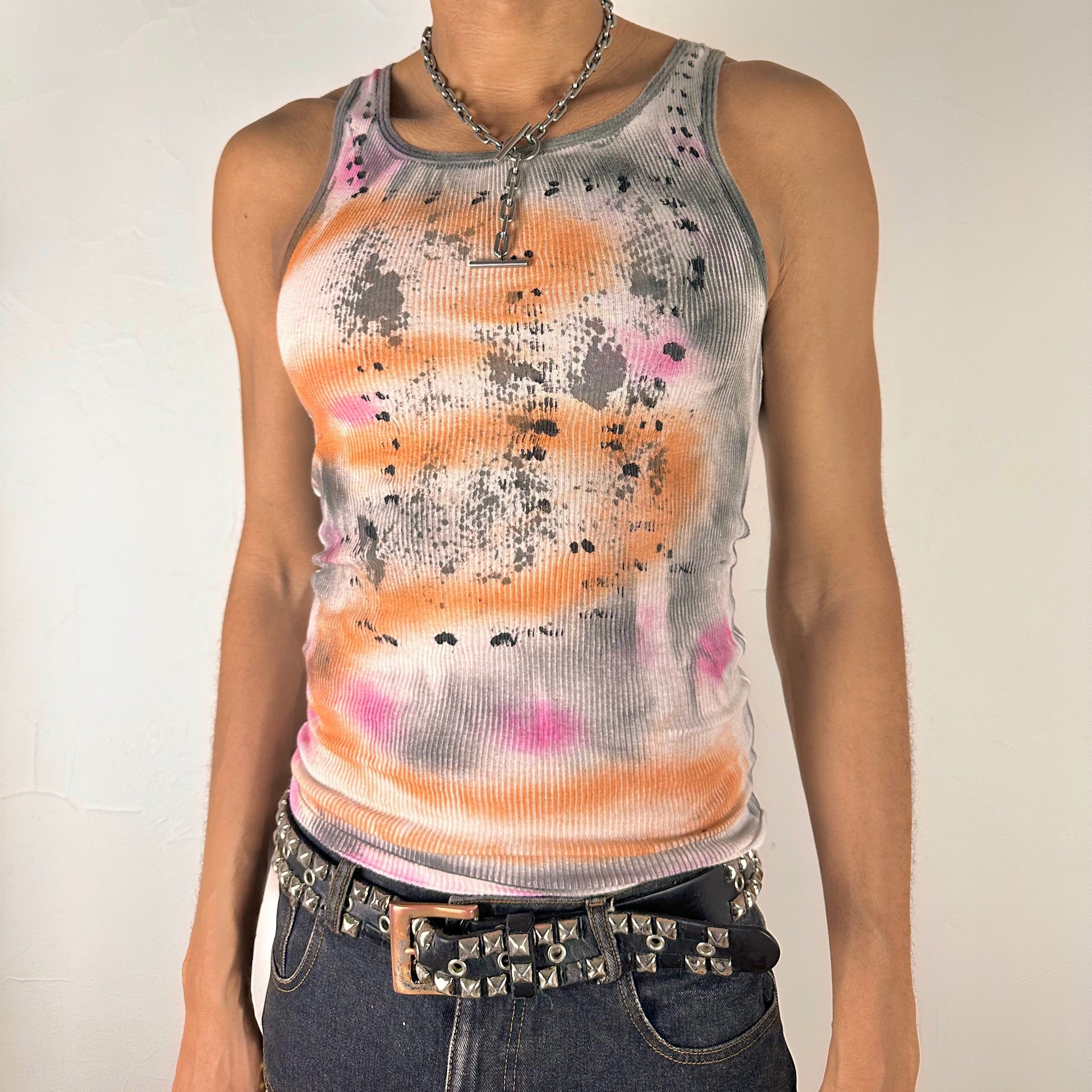 Front of ASTROBOI* x Hanes 'Mars' white ribbed cotton tank top with hand-painted pink, orange, and black abstract graphic, deconstructed cut-outs along chest and sides, customized at ASTROBOI* STUDIO in NYC.