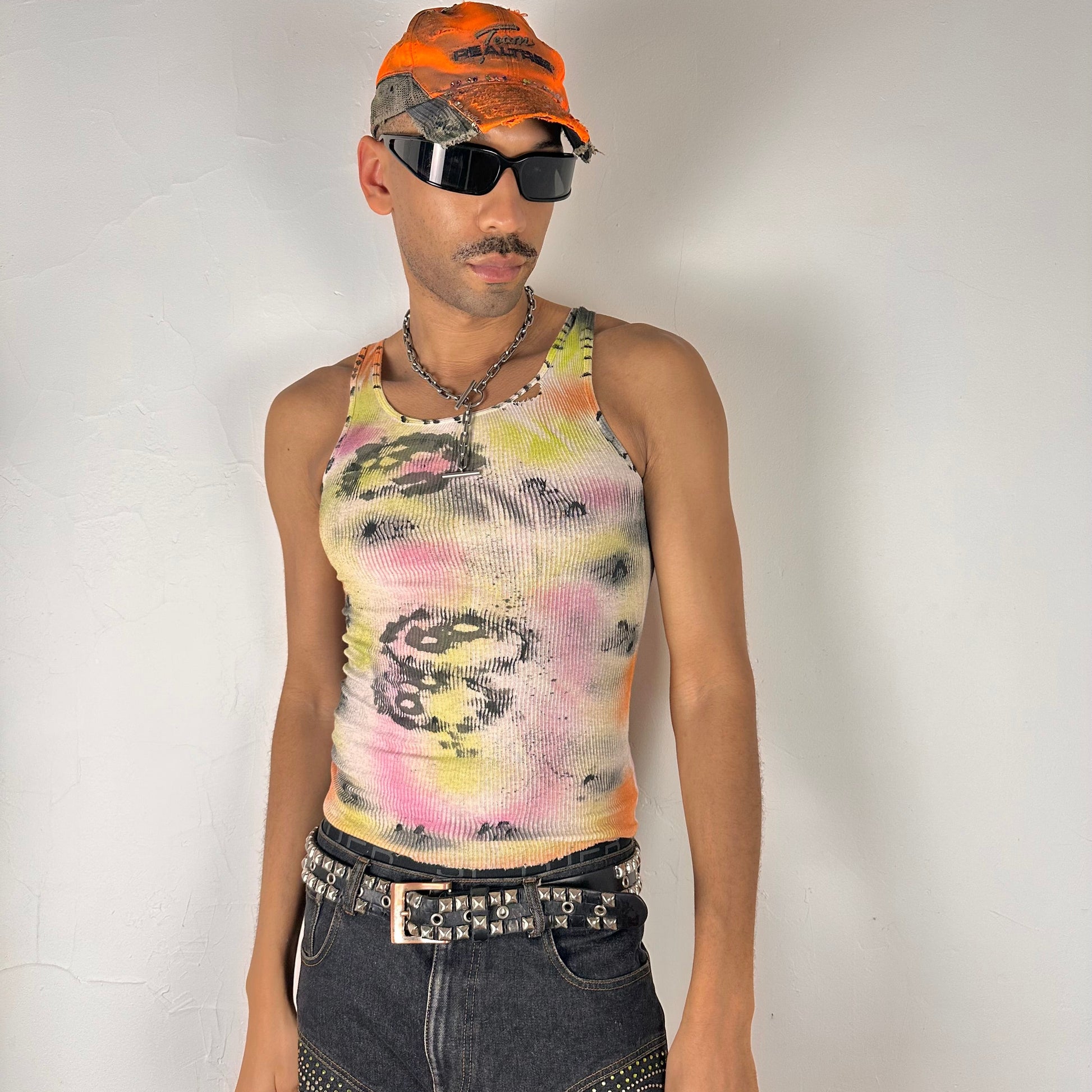 Styled image of ASTROBOI* x Hanes 'Flowers' white ribbed cotton tank top with hand-painted pink and yellow floral design throughout, customized at ASTROBOI* STUDIO in NYC.