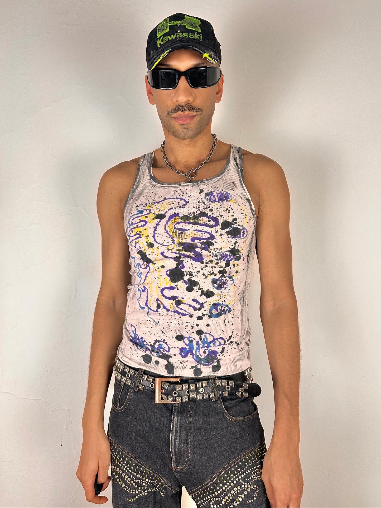 Male model wearing ASTROBOI* x Hanes 'Skies' white abstract graffiti tank top, styled full look, ASTROBOI* STUDIO NYC.