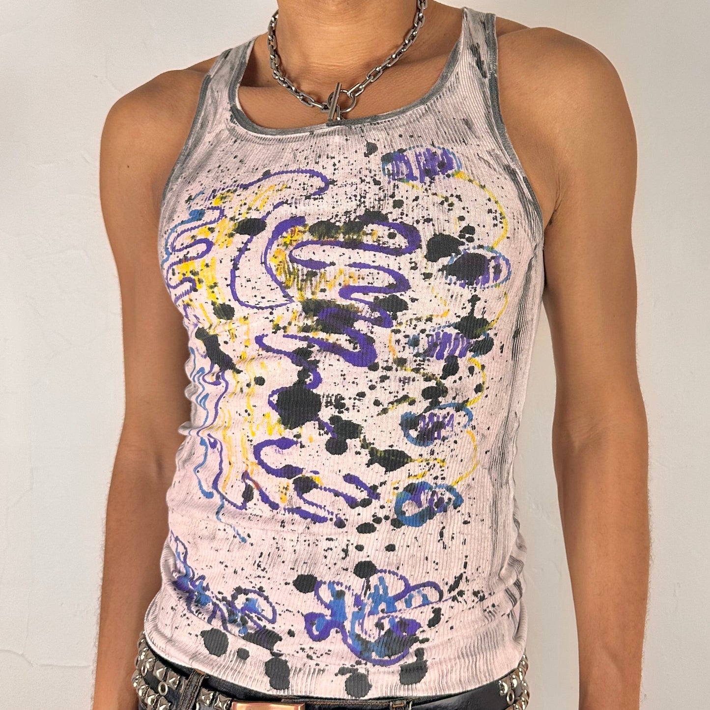 Close-up of ASTROBOI* x Hanes 'Skies' showing hand-painted abstract graffiti scribbles and multicolored spot detailing on white fabric.