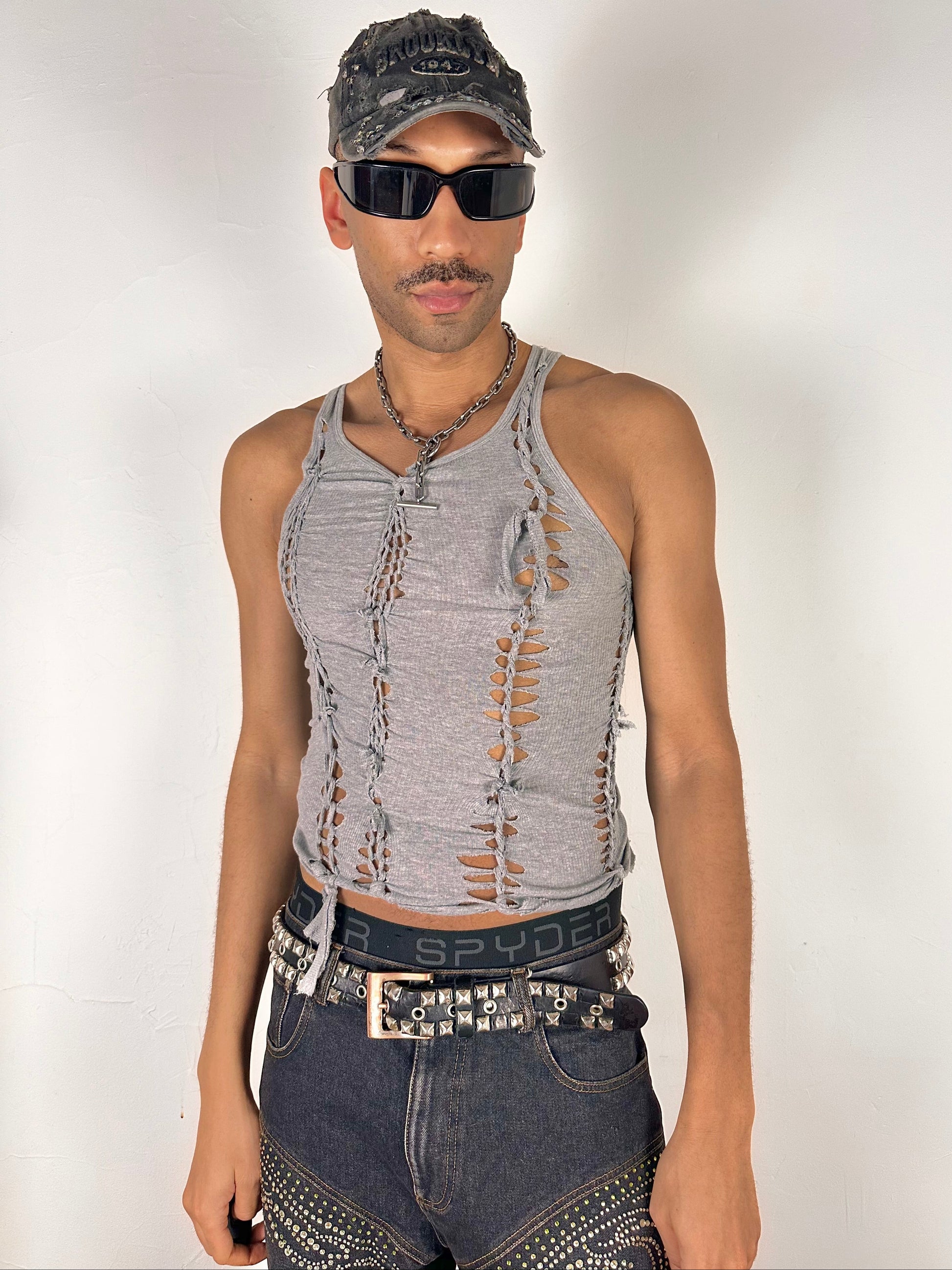Male model wearing ASTROBOI* 'Concrete' gray braided twist tank top, styled full look, ASTROBOI* STUDIO NYC.