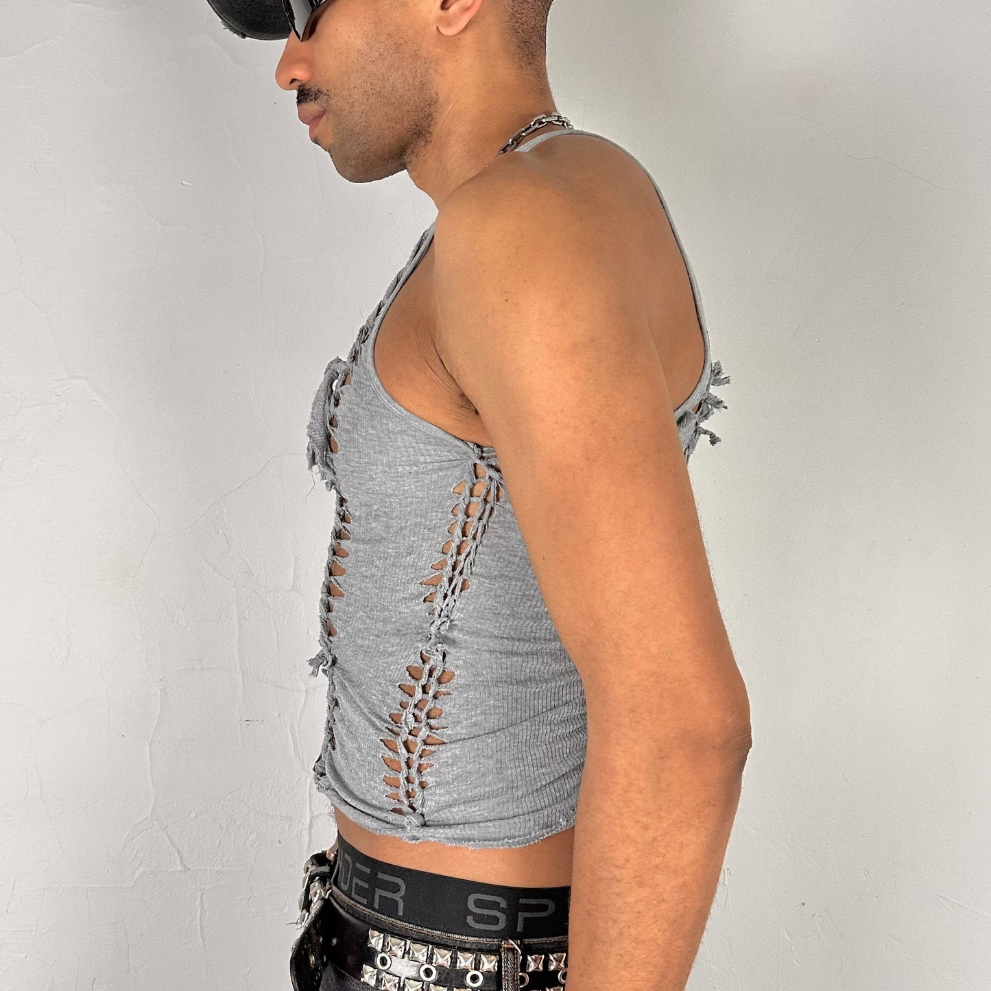 Left side detail of ASTROBOI* 'Concrete' showing hand-braided arrangement, slash, and knot detailing on cropped gray tank.