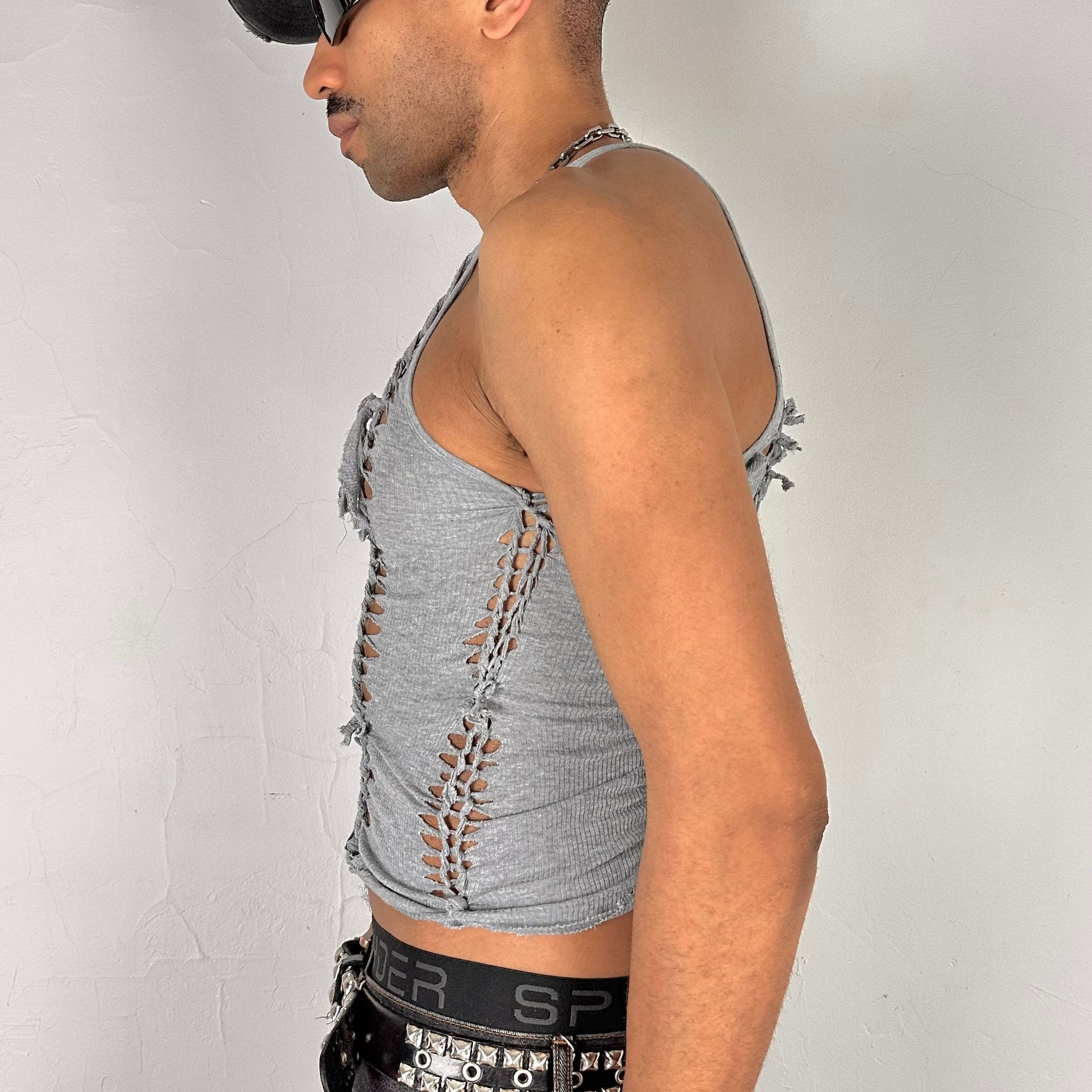 Left side detail of ASTROBOI* 'Concrete' showing hand-braided arrangement, slash, and knot detailing on cropped gray tank.
