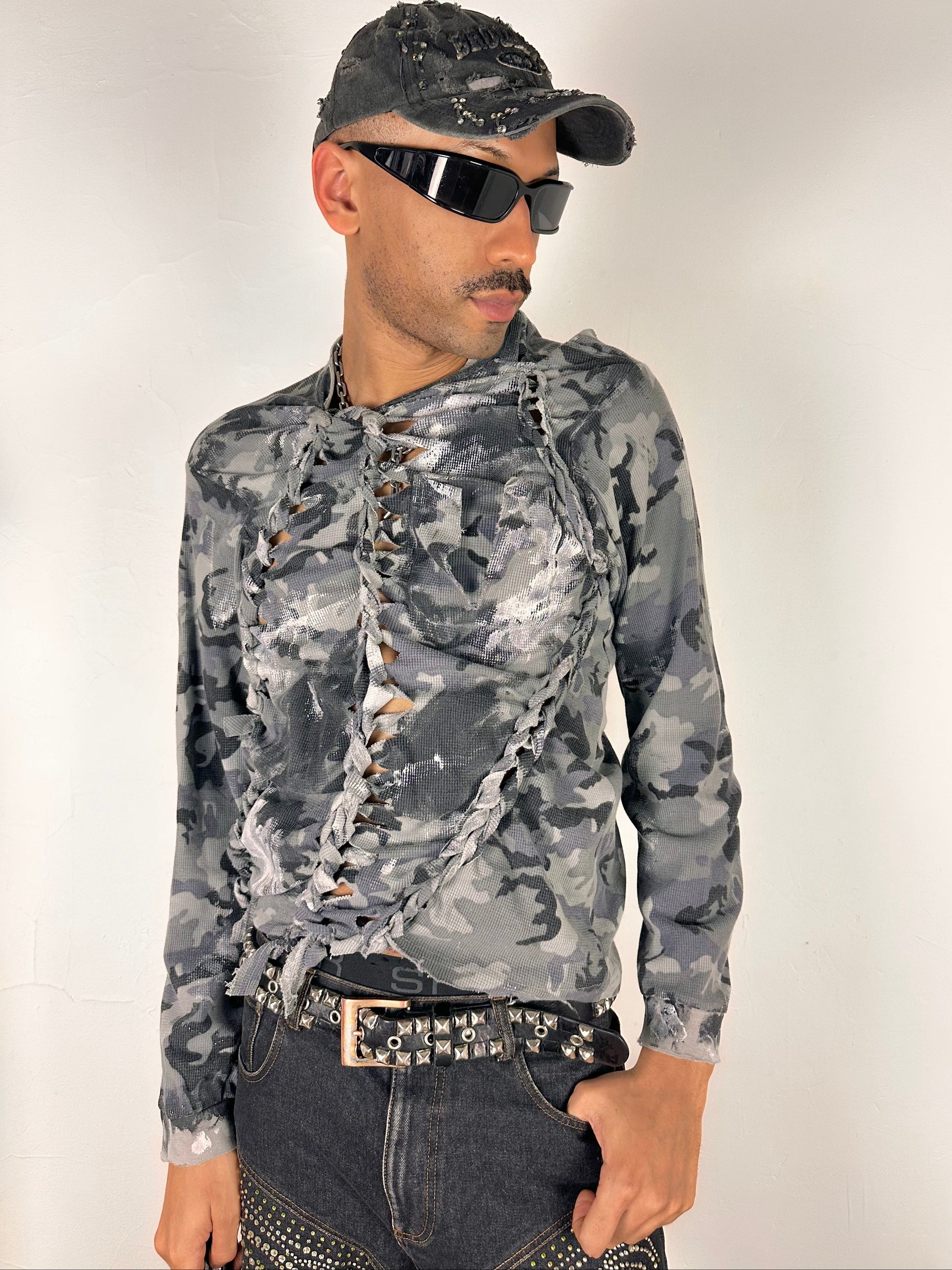 Styled image of ASTROBOI* grey camo braided twist long sleeve t-shirt with white and black hand painted design, slim relaxed fit, size XL.