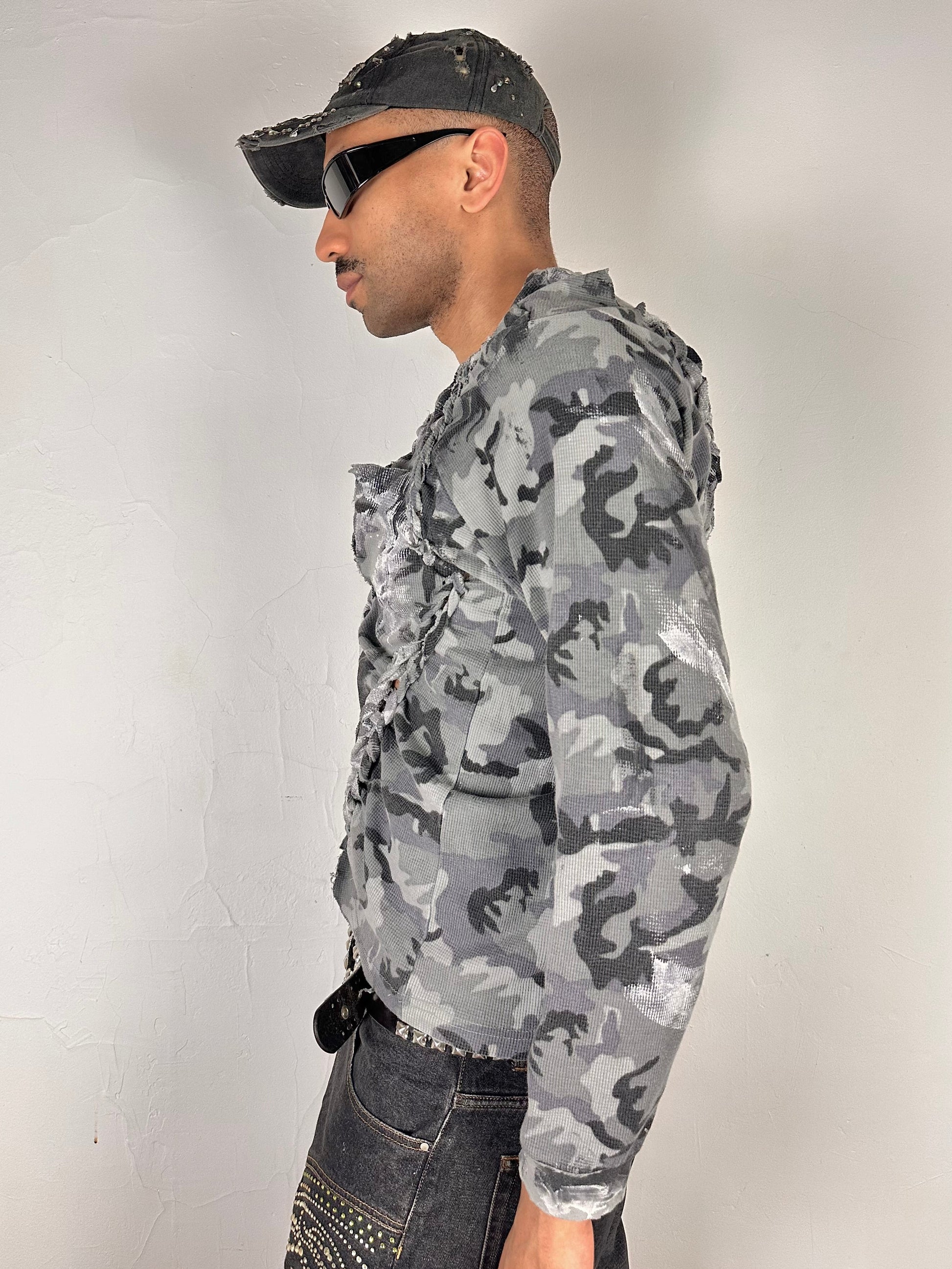 Left side of ASTROBOI* grey camo braided twist long sleeve t-shirt with white and black hand painted design, slim relaxed fit, size XL.