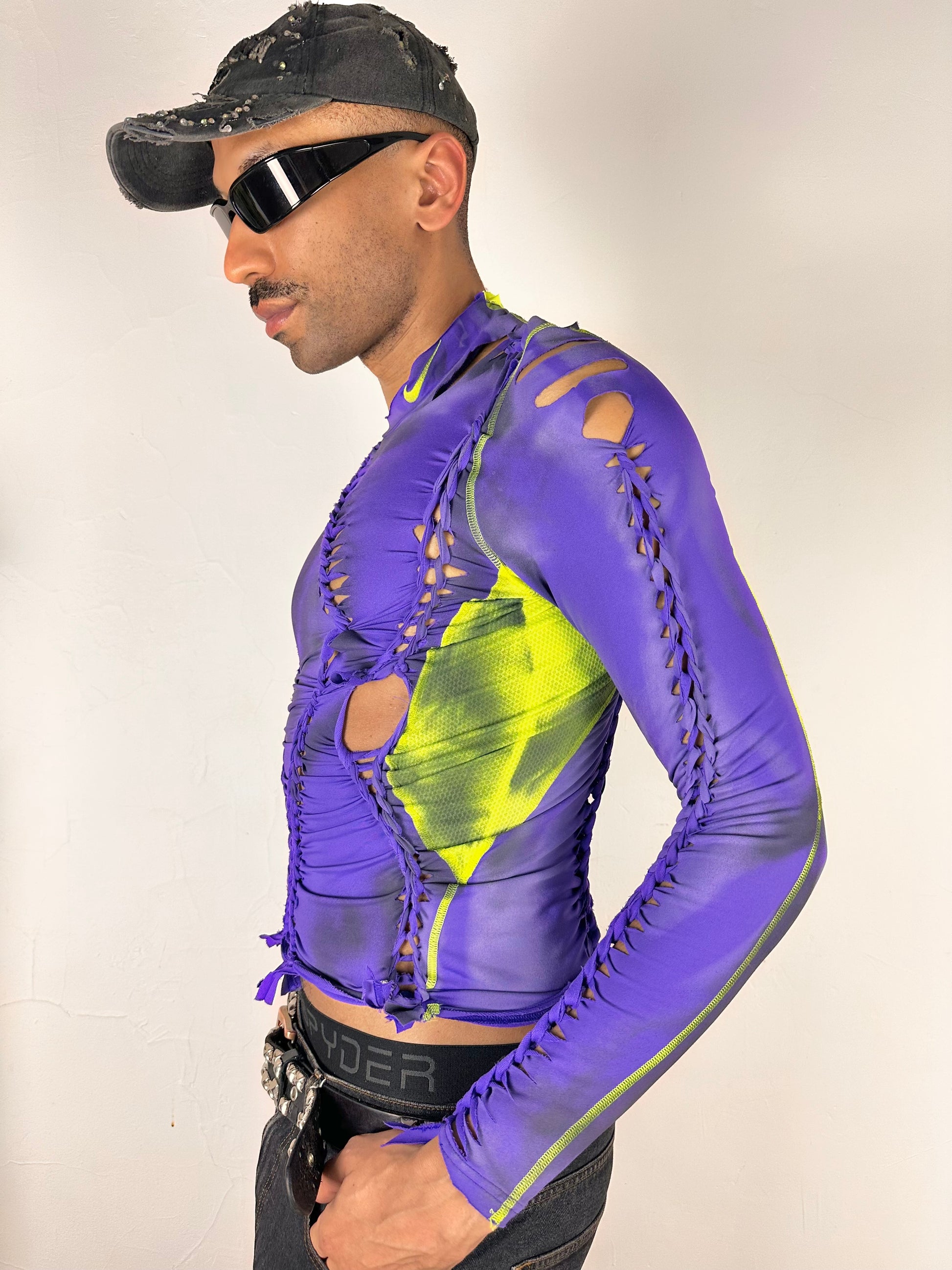 Front left side of ASTROBOI* x Nike Pro purple and green braided compression top in medium with airbrushed details, mesh side panels, and slim athletic fit.