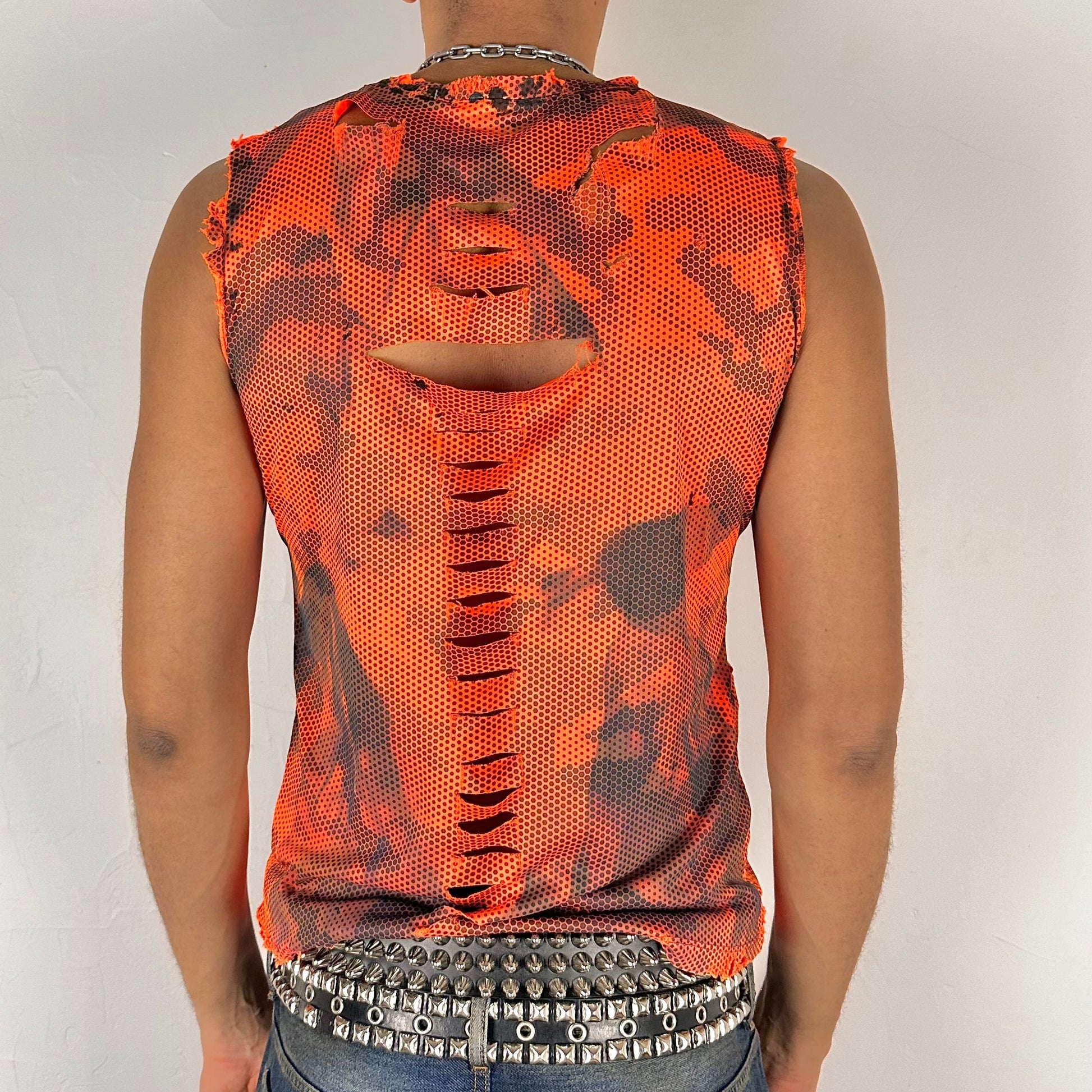 ASTROBOI* 'Home Depot' blaze orange grunge camo tank top, rear view showing design cuts and paint treatment construction, worn by male model.
