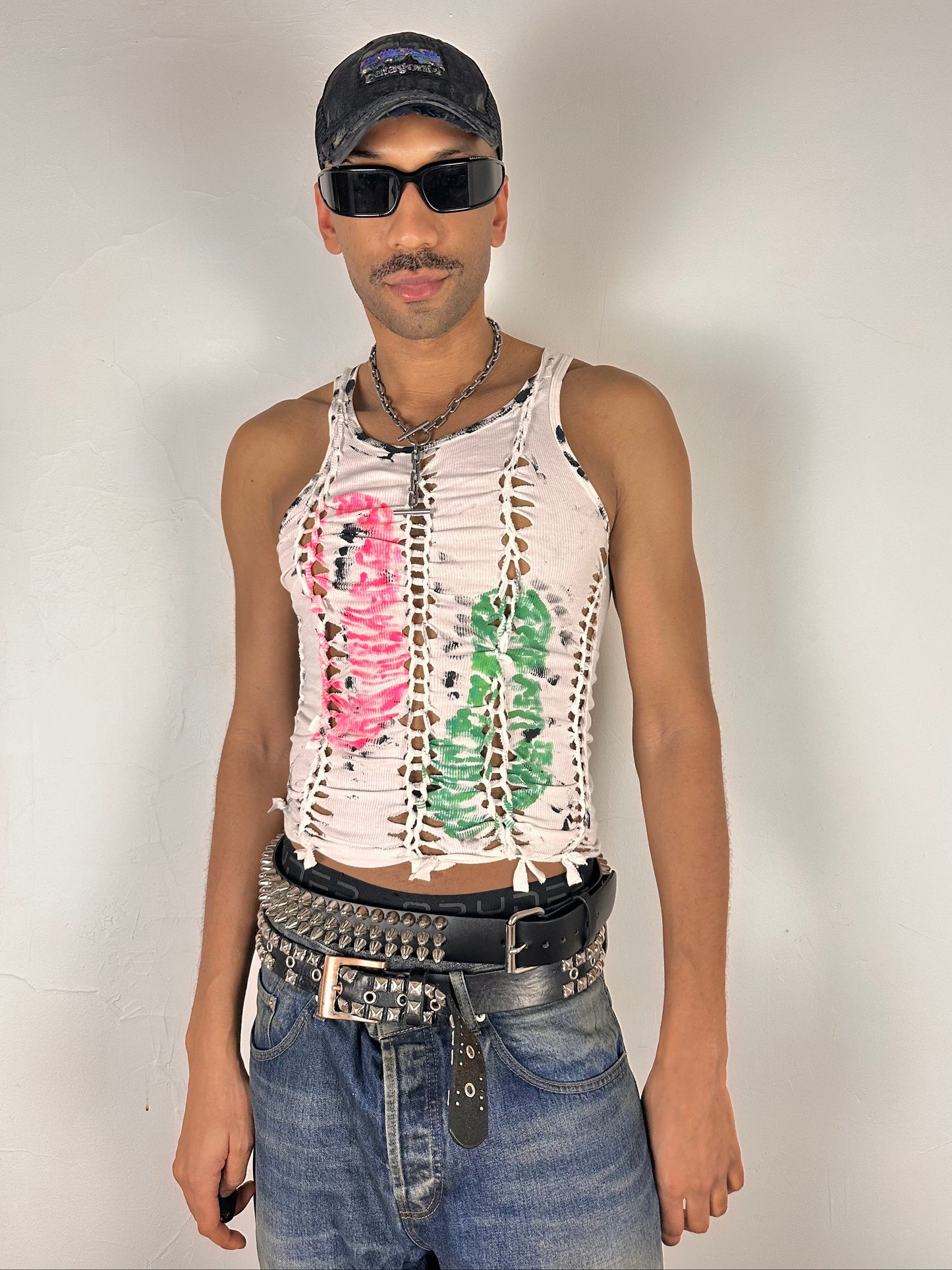 Male model wearing ASTROBOI* x Calvin Klein 'Mile in Our Shoes' white braided twist tank top, styled full look, ASTROBOI* STUDIO NYC.