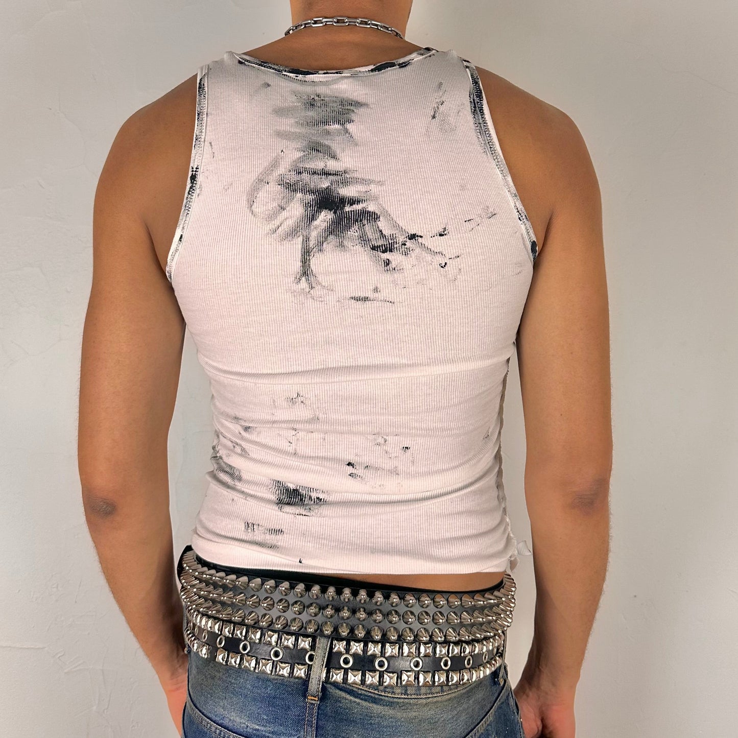 ASTROBOI* x Calvin Klein 'Mile in Our Shoes' white braided twist tank top, rear view showing slim-fit construction and paint detail, worn by male model.