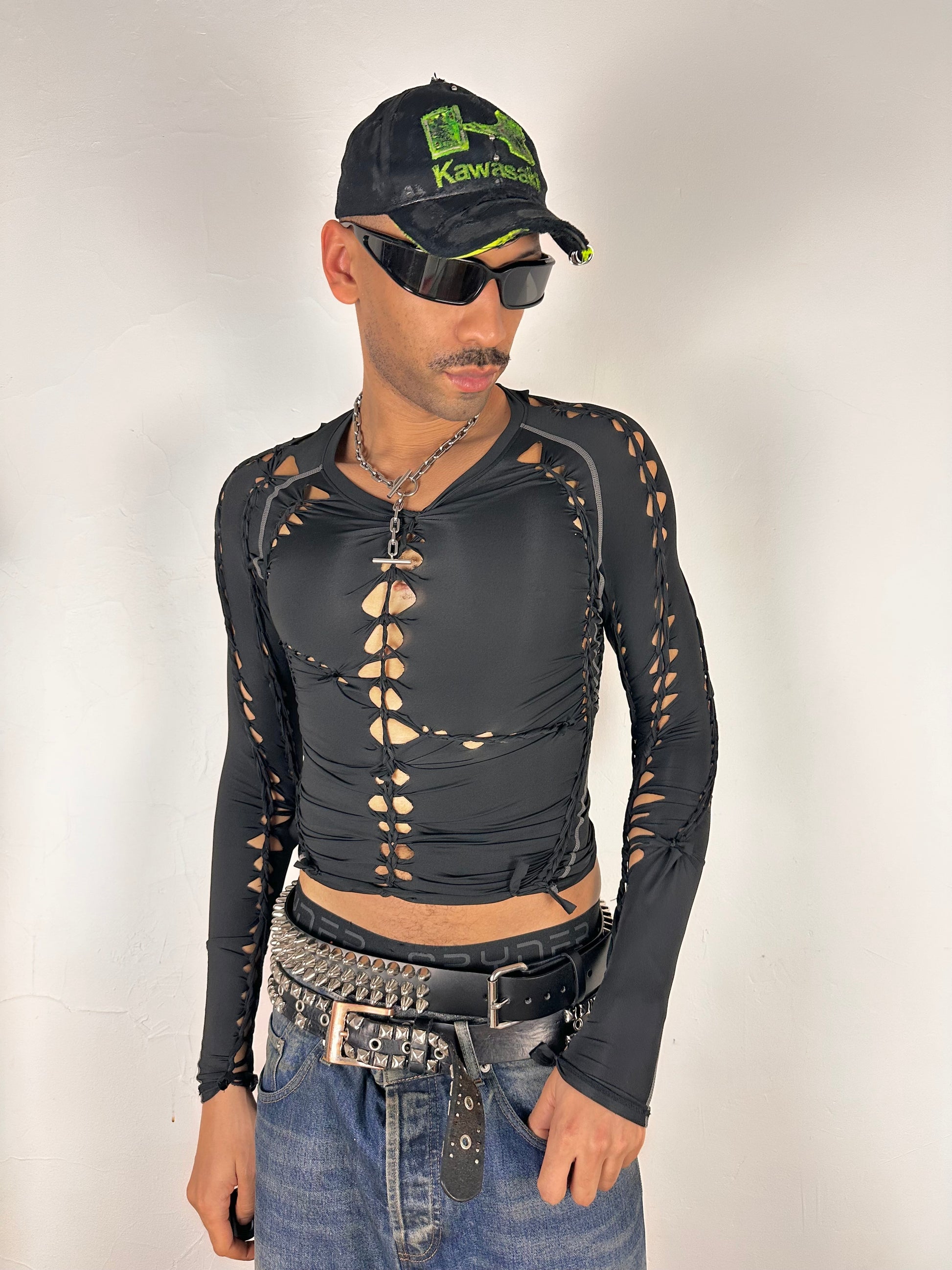 Styled image of of ASTROBOI* 'Mystique' black braided twist compression top with cut-out details. Handmade in NYC using breathable, moisture-wicking stretch fabric.