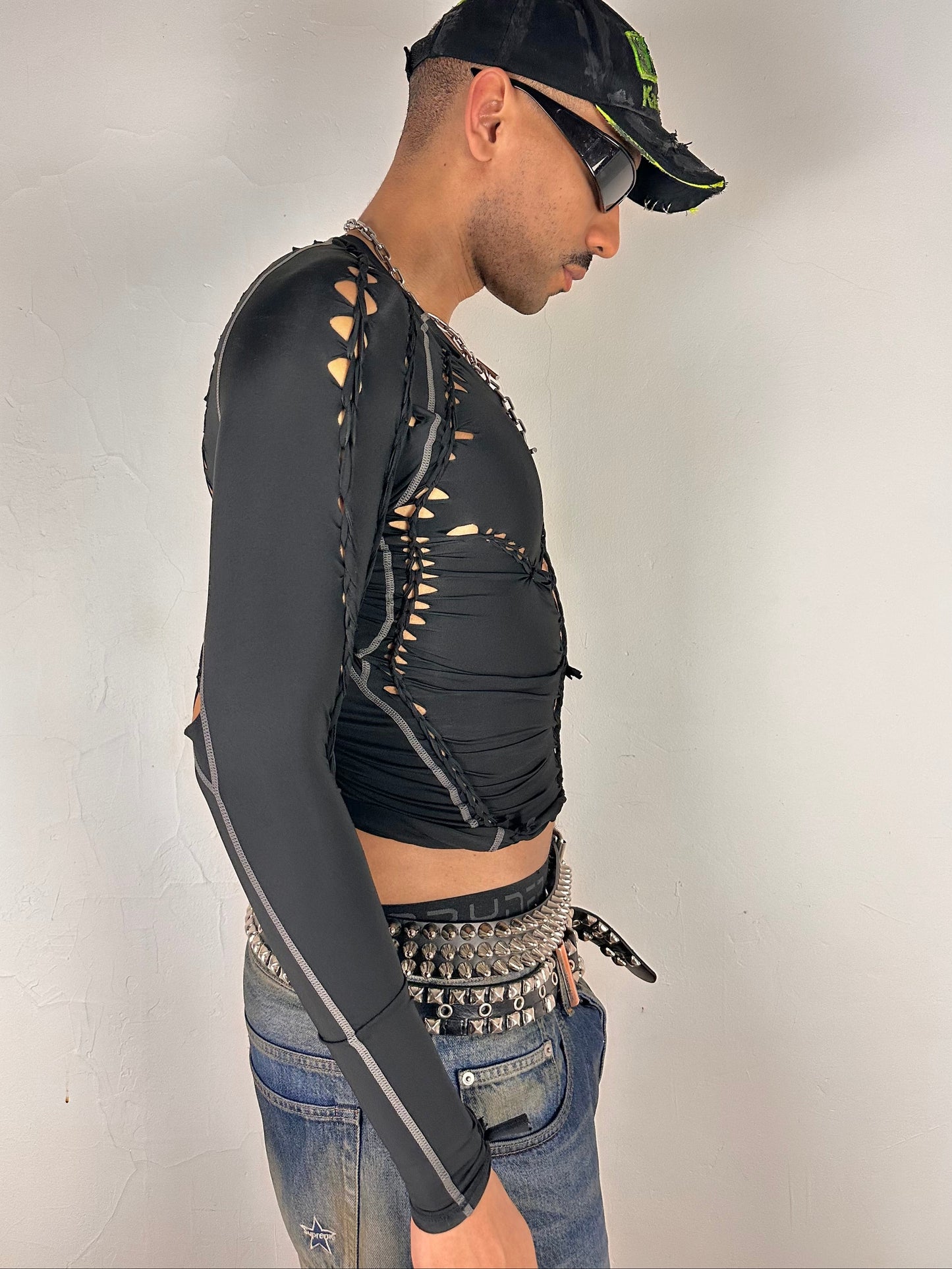 RIght side of ASTROBOI* 'Mystique' black braided twist compression top with cut-out details. Handmade in NYC using breathable, moisture-wicking stretch fabric.