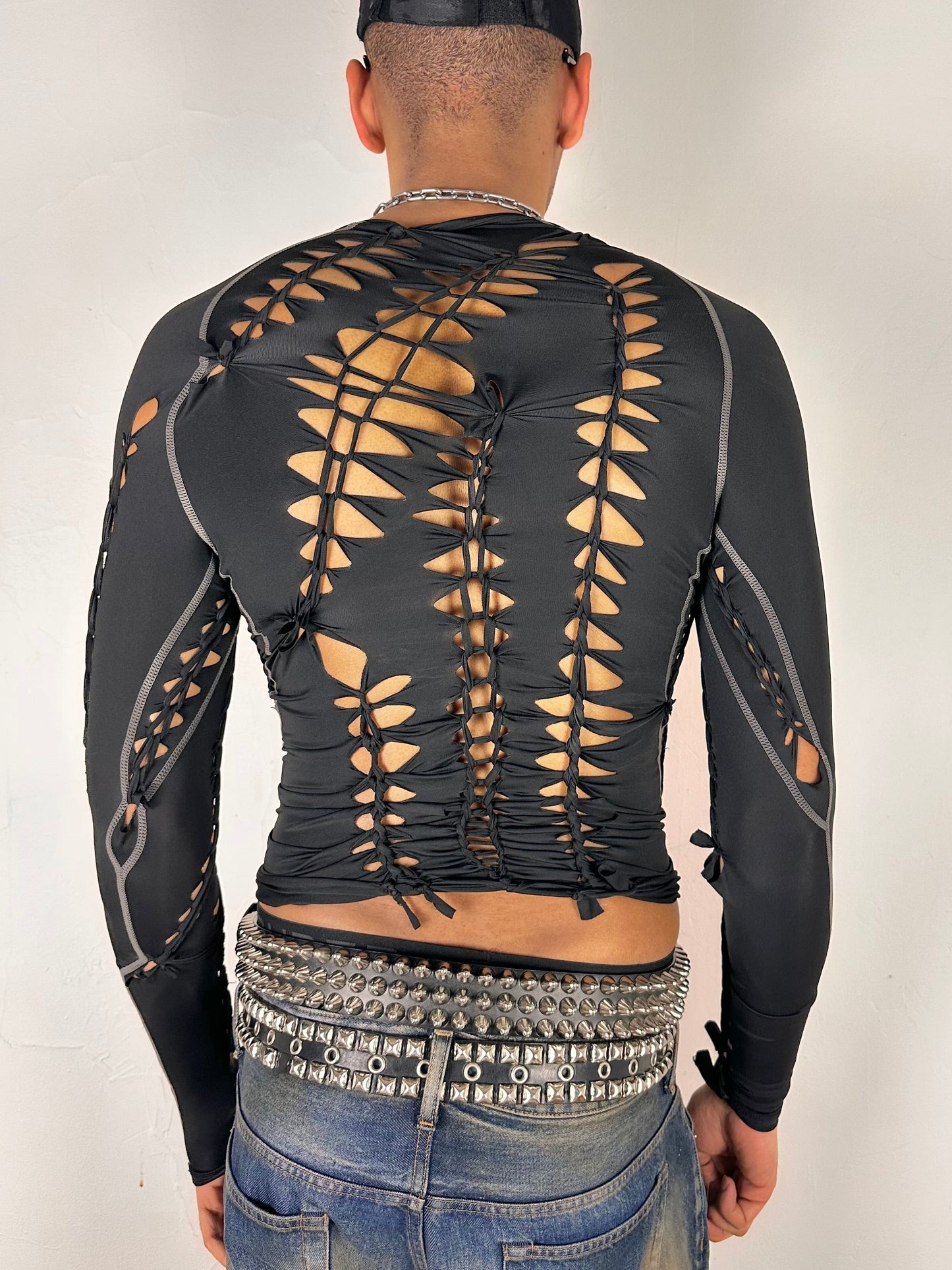 Back side of ASTROBOI* 'Mystique' black braided twist compression top with cut-out details. Handmade in NYC using breathable, moisture-wicking stretch fabric.