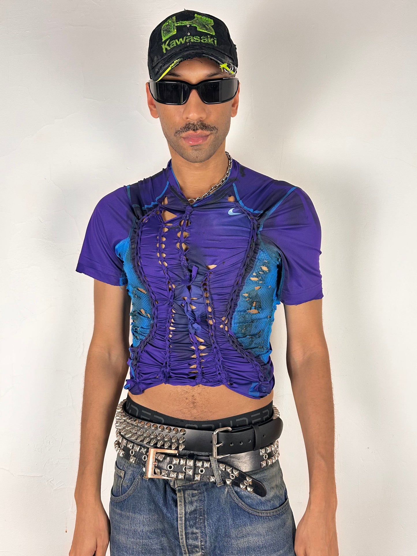 Styled image of ASTROBOI* x Under Armour black braided compression top in large with slim stretch fit, twist detailing, and UA logos at chest and back.