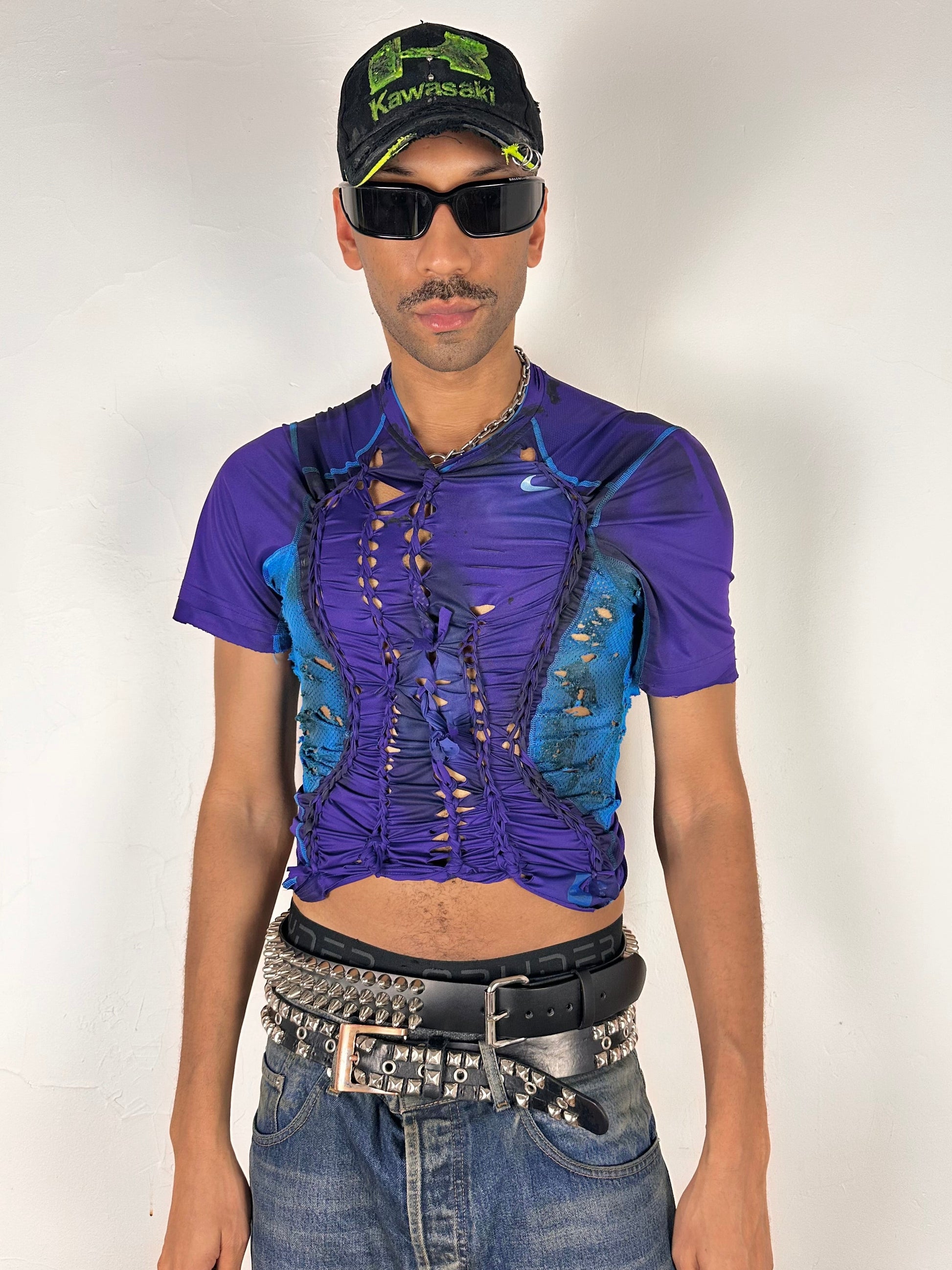 Styled image of ASTROBOI* x Under Armour black braided compression top in large with slim stretch fit, twist detailing, and UA logos at chest and back.