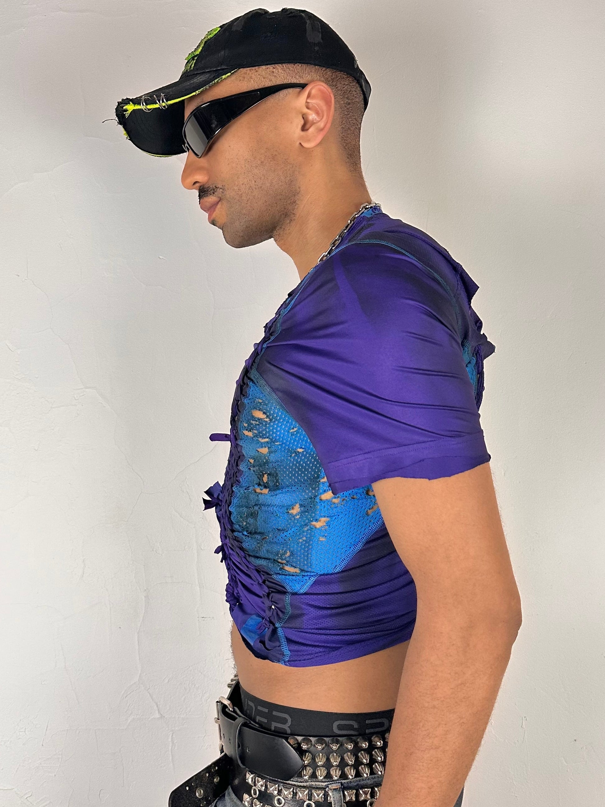 Left side of ASTROBOI* x Under Armour black braided compression top in large with slim stretch fit, twist detailing, and UA logos at chest and back.