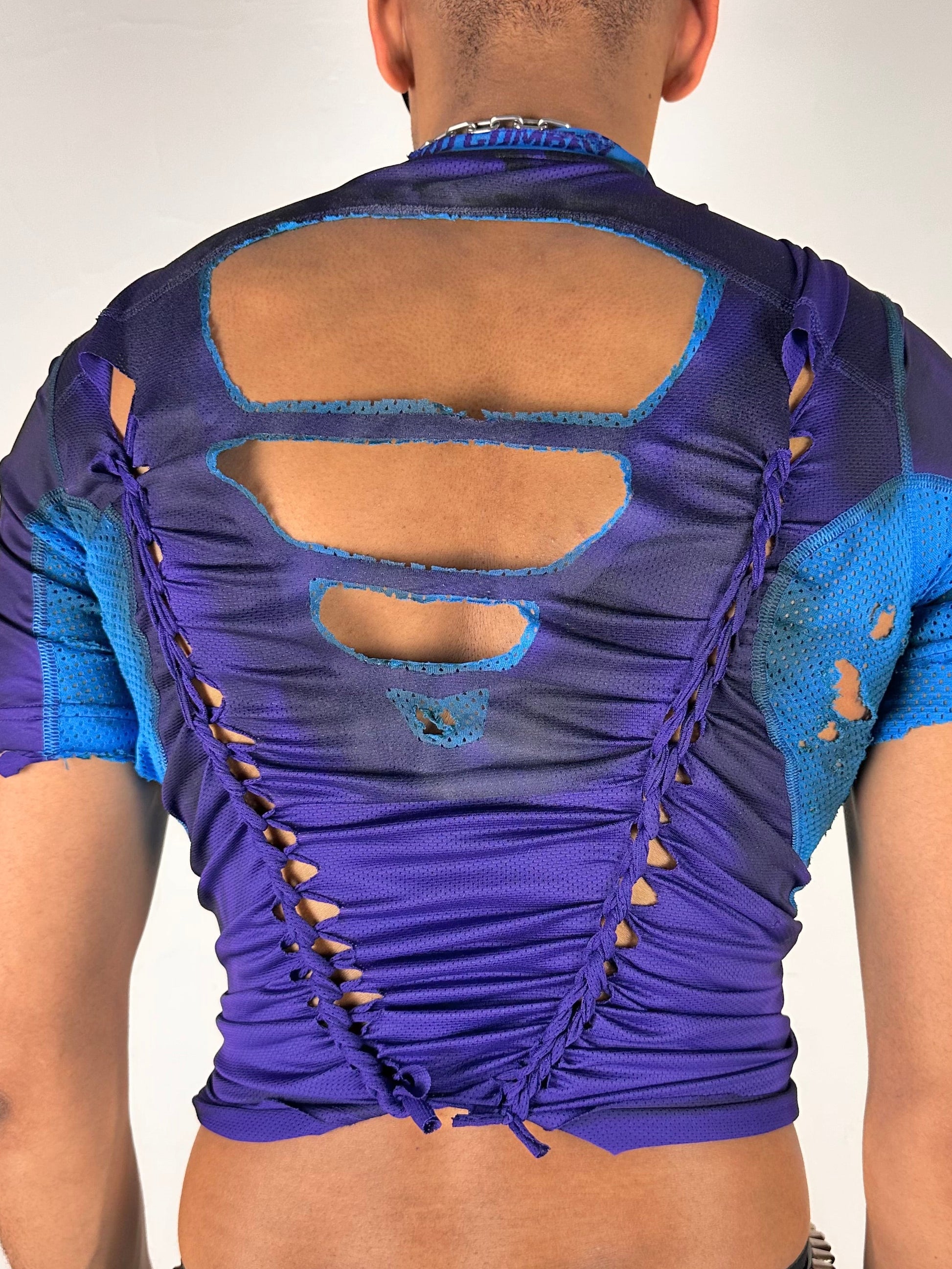 Back detail on ASTROBOI* x Under Armour black braided compression top in large with slim stretch fit, twist detailing, and UA logos at chest and back.