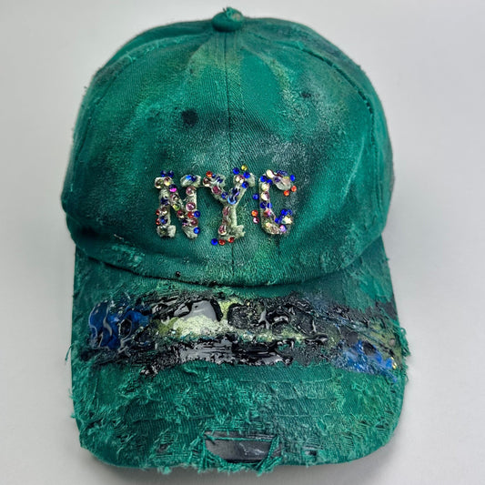 Overview of ASTROBOI* Smith NYC green distressed hat with clear rhinestone logo, custom paint treatment and blue black resin textured visor.